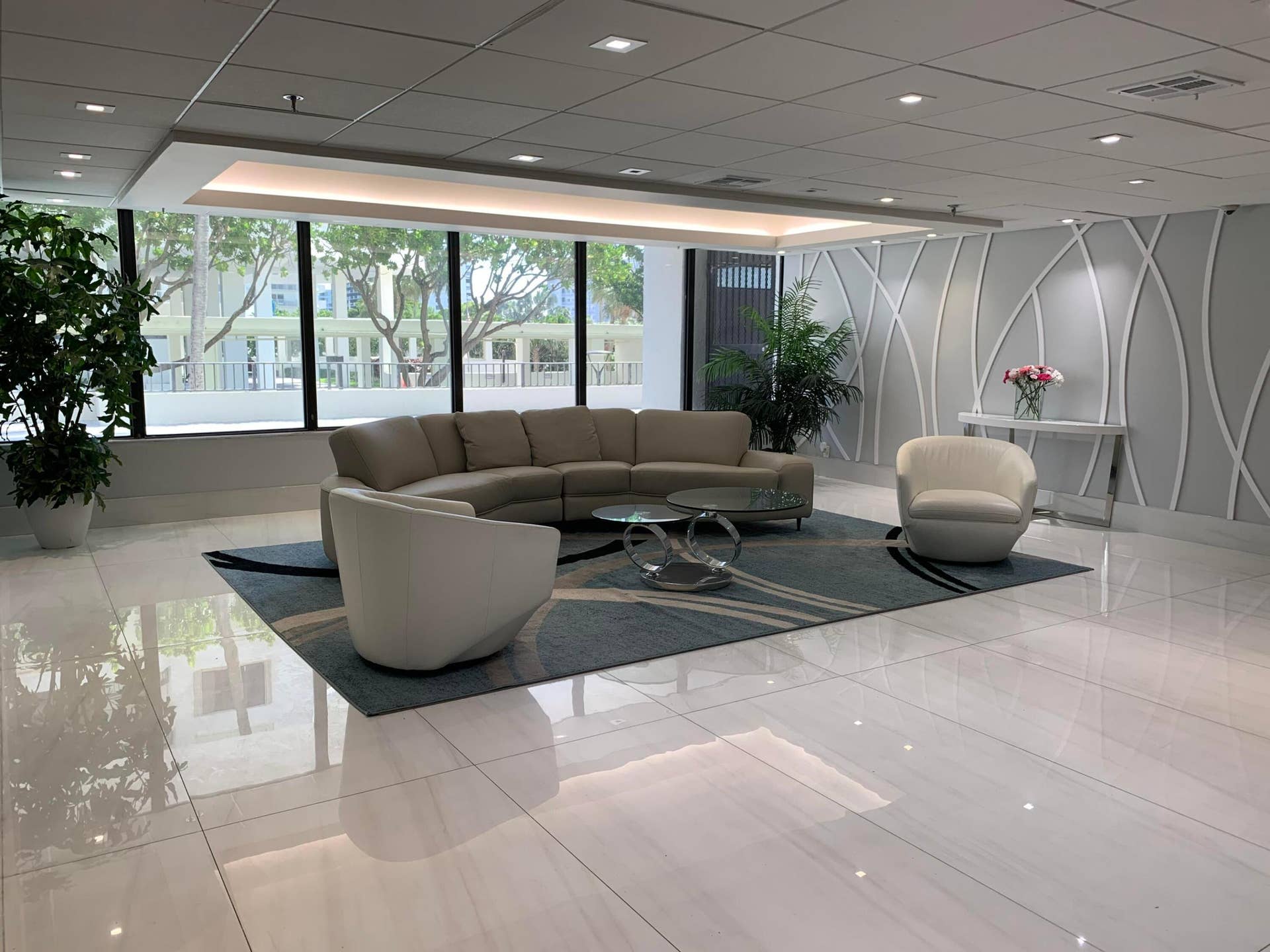 3115 S Ocean Boulevard, #1002, Highland Beach, FL 33487 Lobby area featuring large format polished tile flooring, full-height windows, recessed lighting, and a decorative wall panel accent