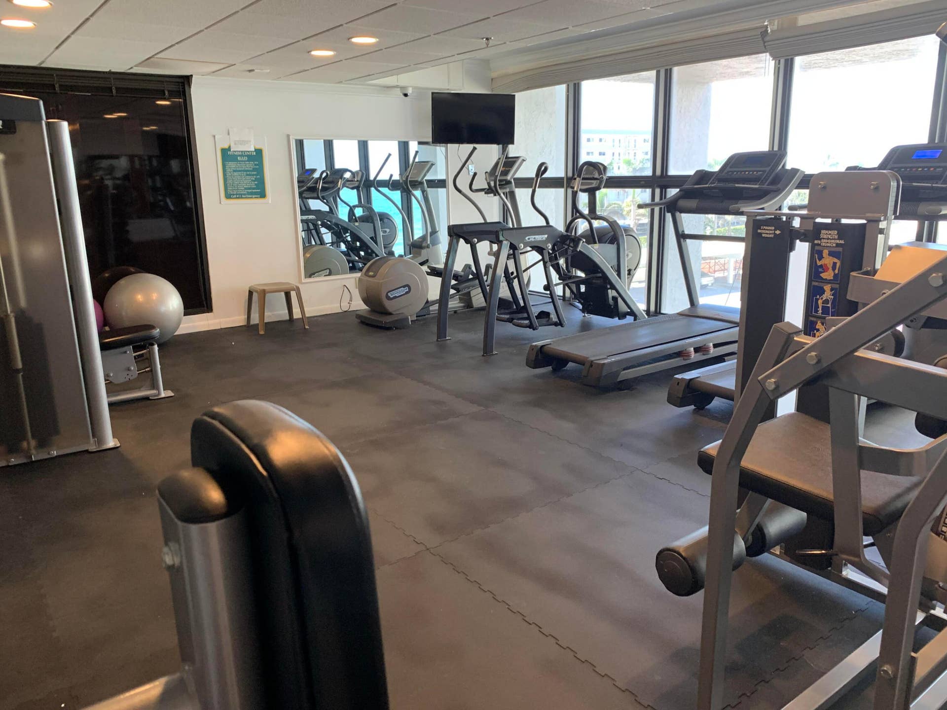 3115 S Ocean Boulevard, #1002, Highland Beach, FL 33487 Fitness center featuring a rubberized floor, mirrored wall, and floor-to-ceiling windows