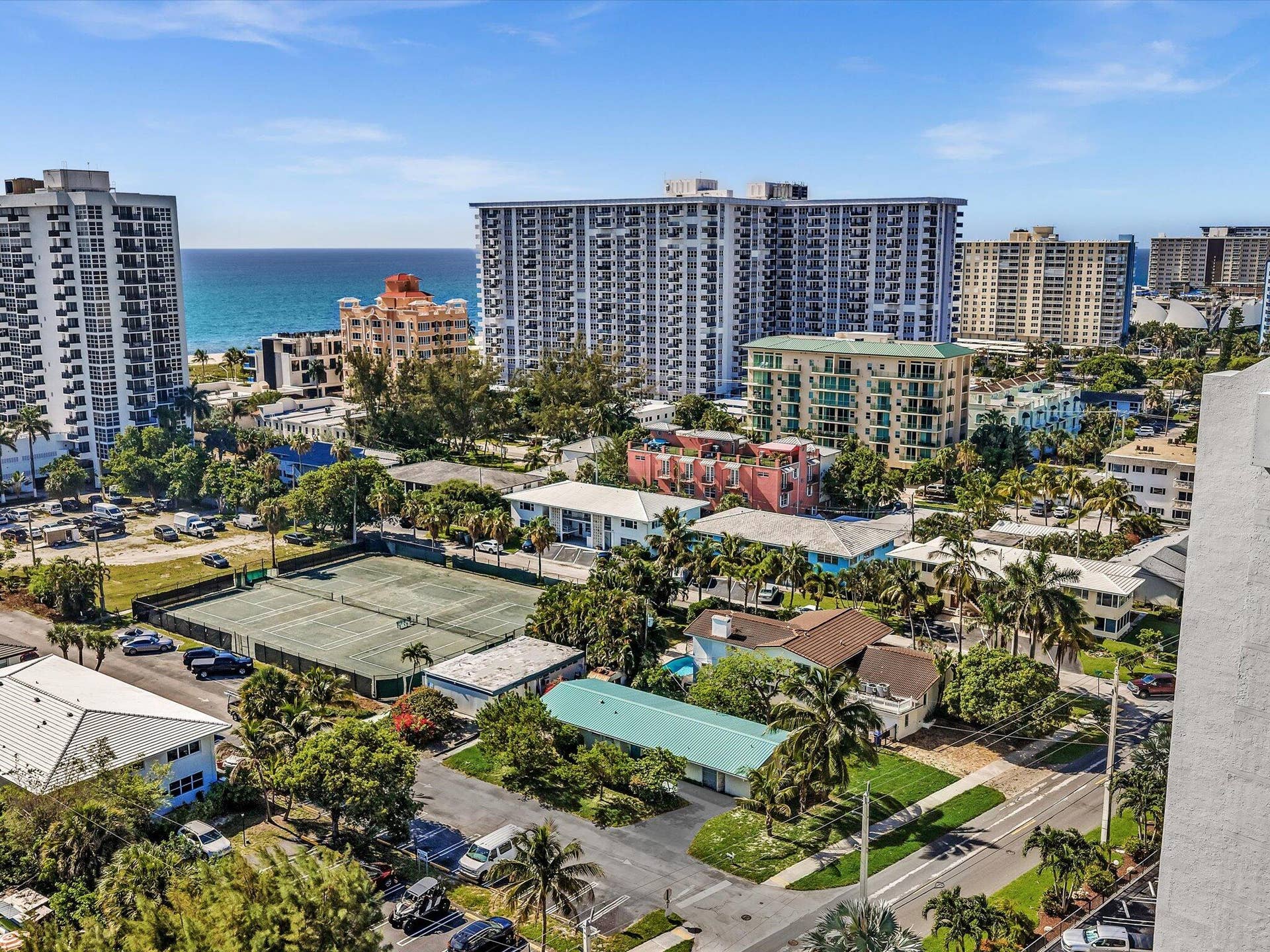 518 N Riverside Drive, Pompano Beach, FL 33062 Aerial perspective showcasing a coastal cityscape with the ocean horizon