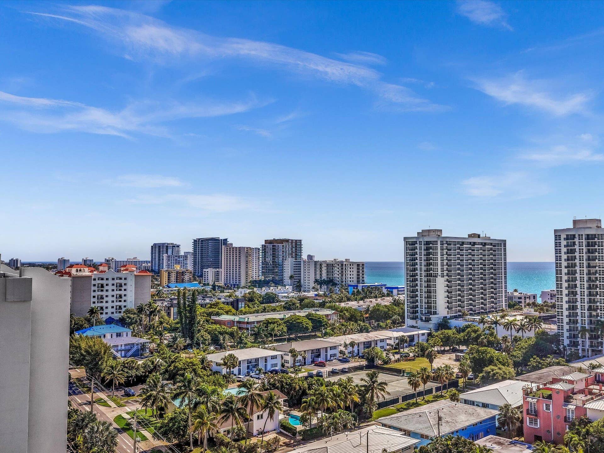 518 N Riverside Drive, Pompano Beach, FL 33062 Expansive city and ocean panorama featuring multiple high-rise buildings and mature palm trees