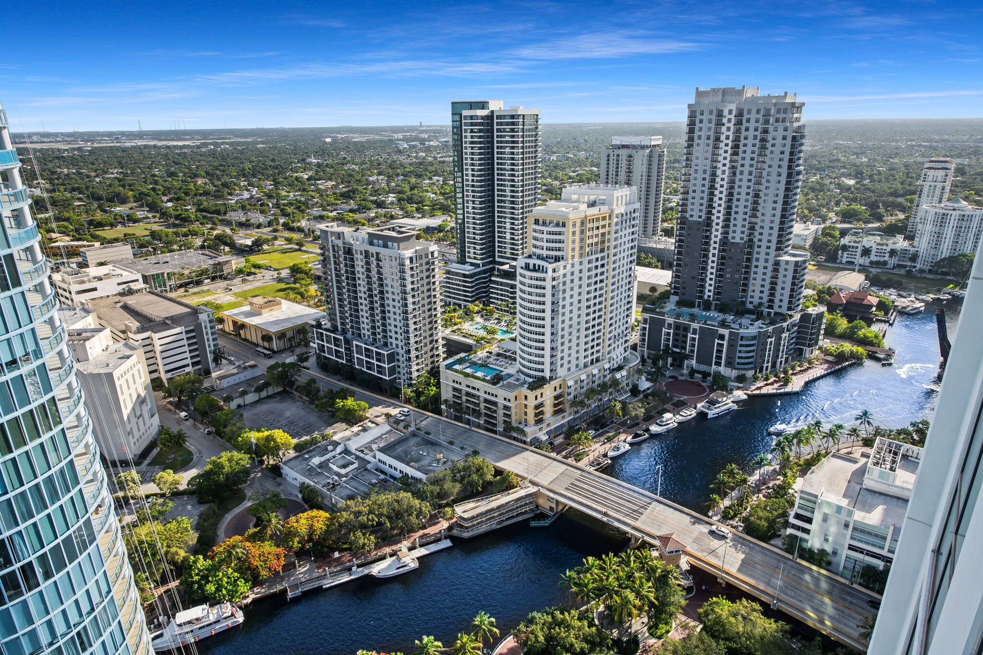 100 E Las Olas Boulevard, #3804, Fort Lauderdale, FL 33301 Urban waterside setting featuring multiple high-rise structures, a waterway with docked boats, and a prominent bridge