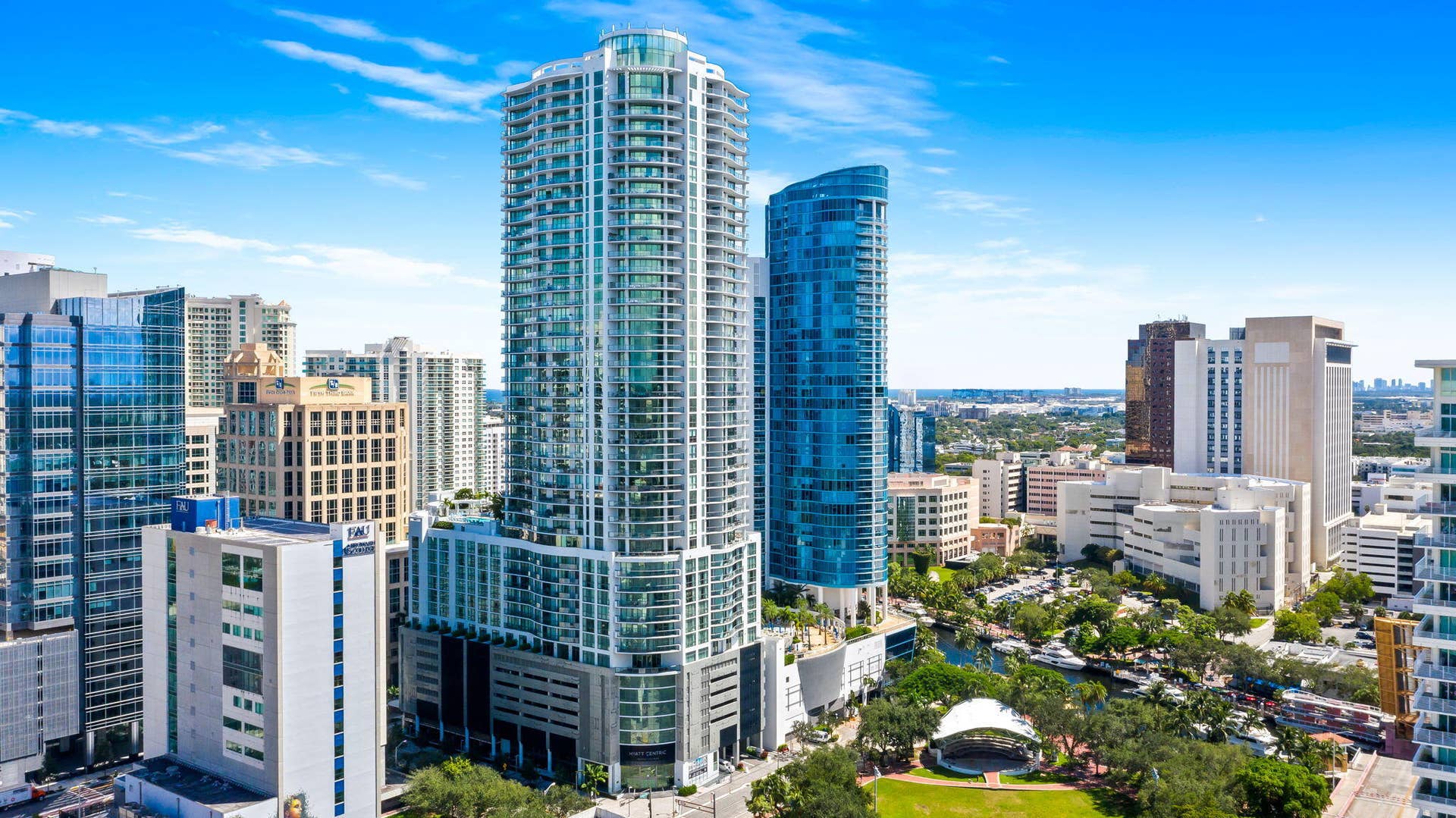 100 E Las Olas Boulevard, #3804, Fort Lauderdale, FL 33301 Modern high-rise building featuring a glass and concrete facade, multiple balconies, and a structured parking garage