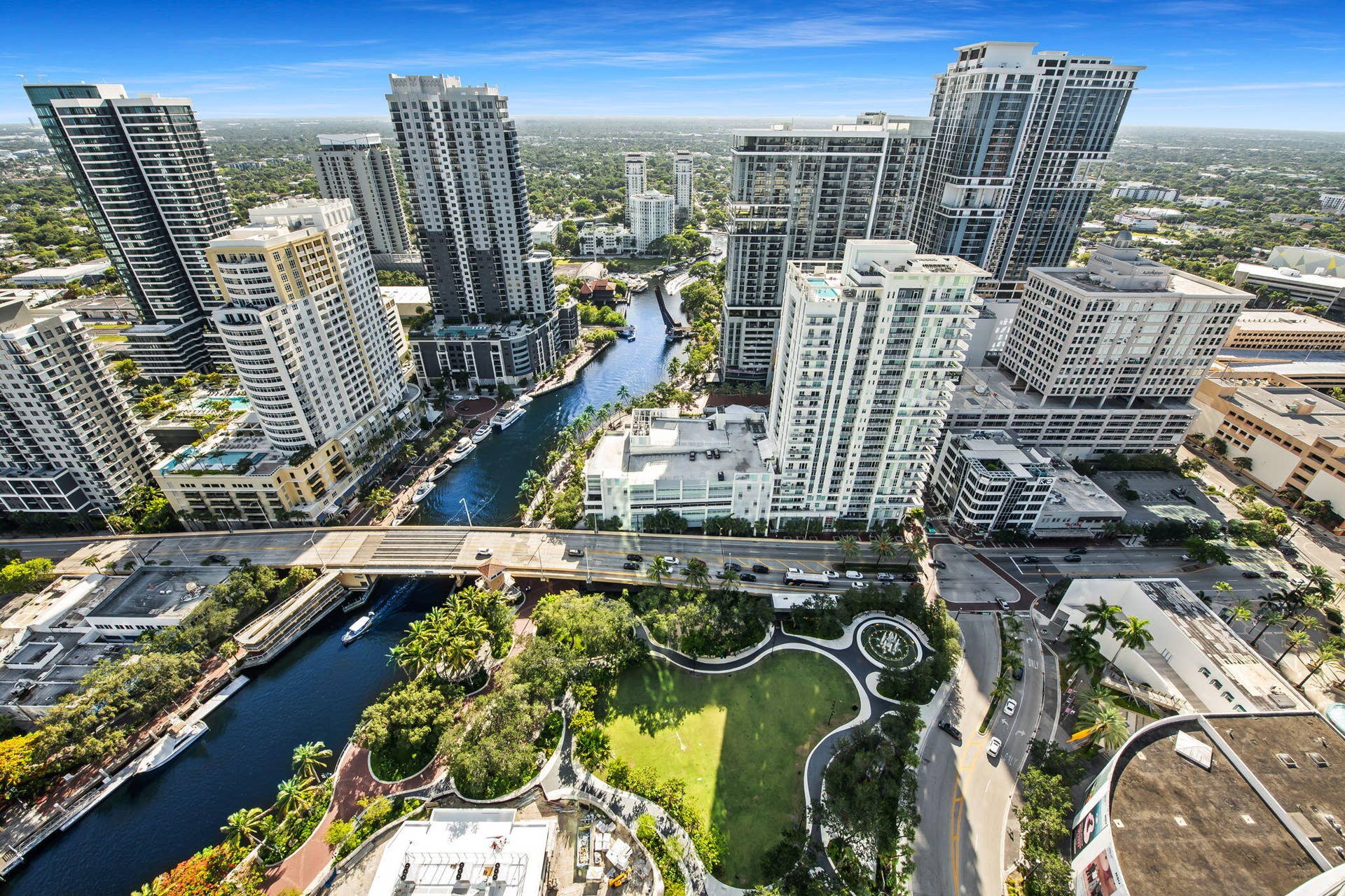 100 E Las Olas Boulevard, #3804, Fort Lauderdale, FL 33301 Aerial perspective of a vibrant metropolitan area featuring a river, multiple high-rise buildings, extensive green spaces, and prominent roadways