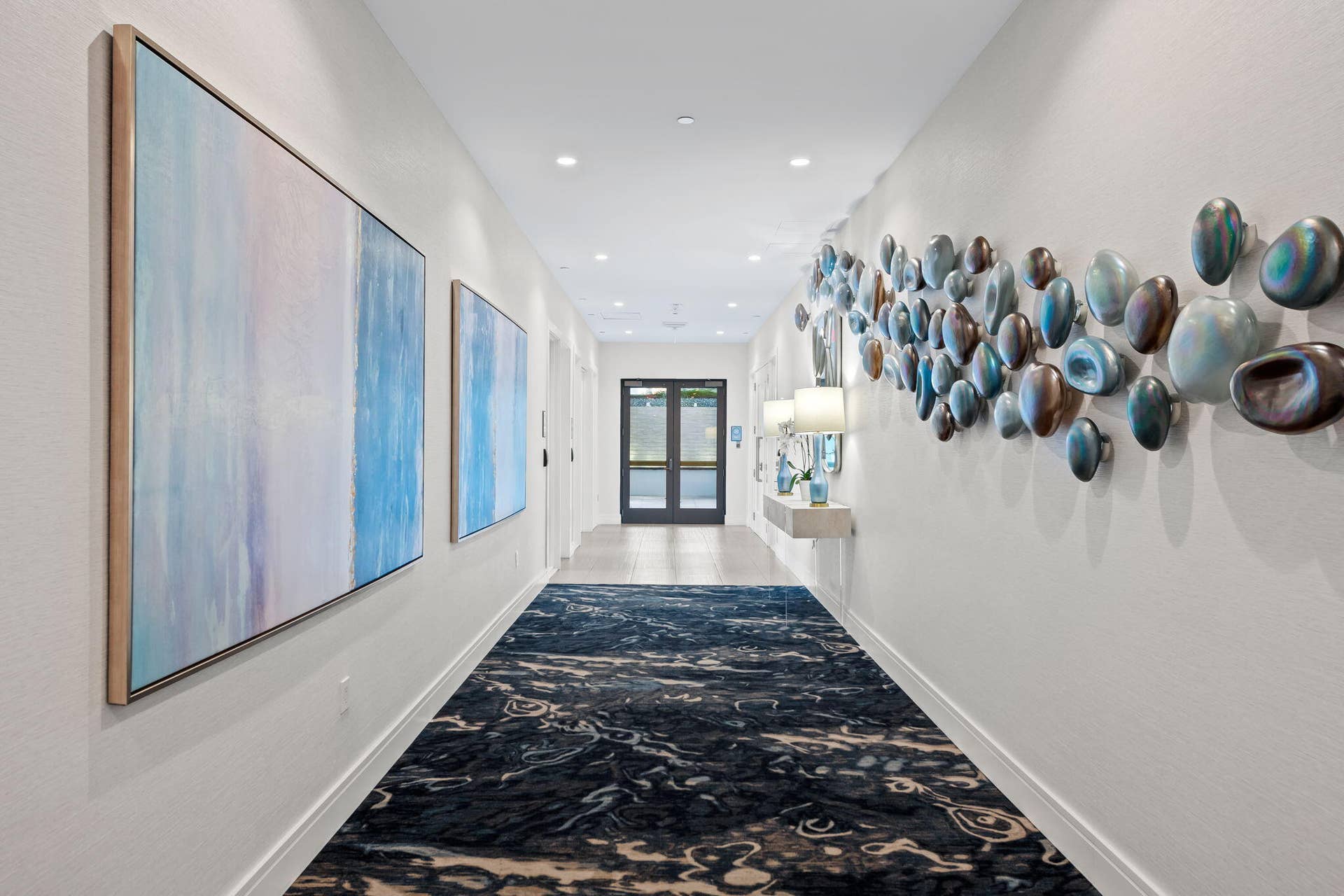 100 E Las Olas Boulevard, #3804, Fort Lauderdale, FL 33301 Long corridor featuring recessed lighting, a patterned area rug, and paneled walls