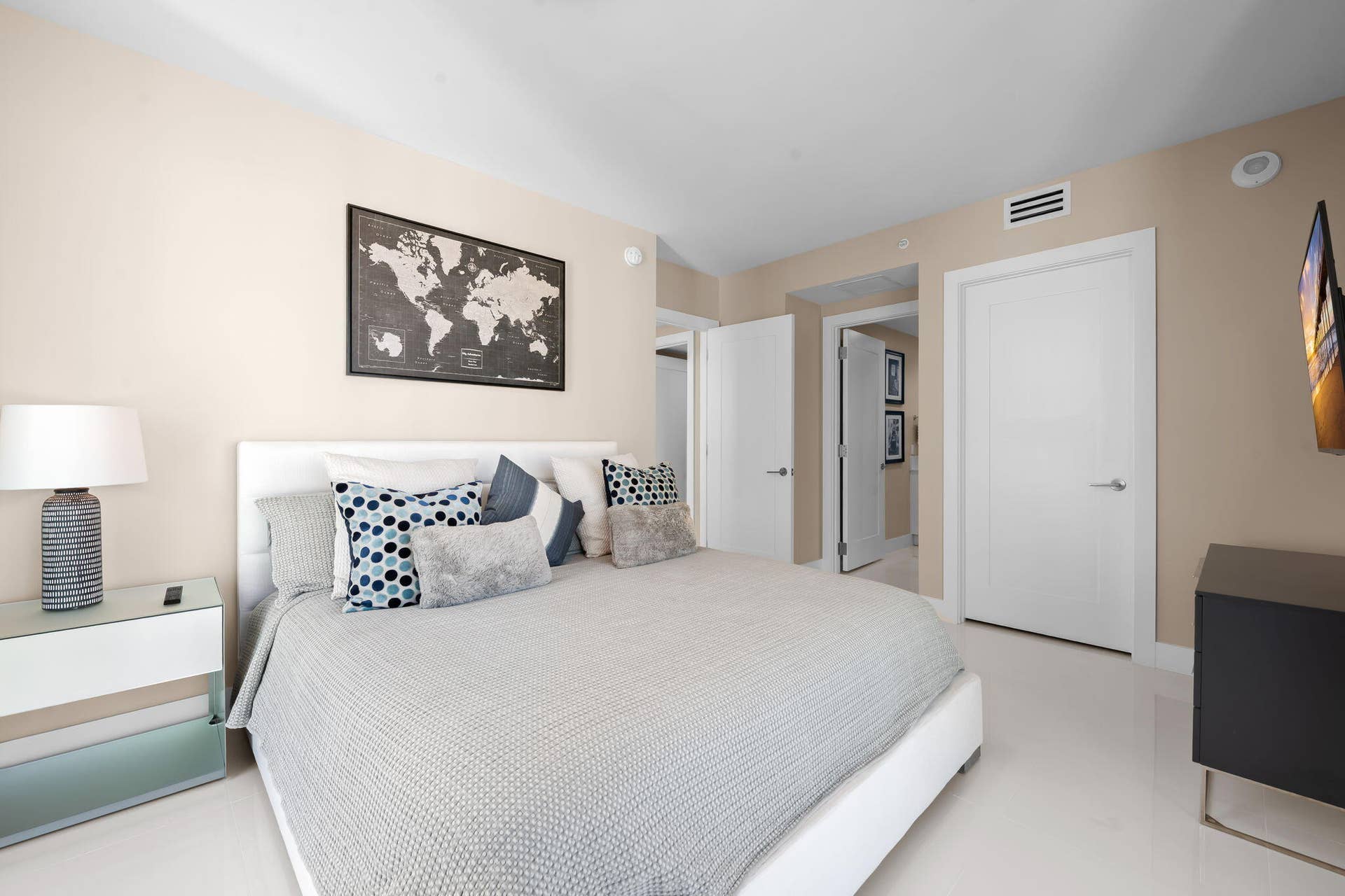 100 E Las Olas Boulevard, #3804, Fort Lauderdale, FL 33301 Neutral-toned bedroom featuring crisp white doors with brushed chrome hardware, recessed lighting, and light-colored flooring