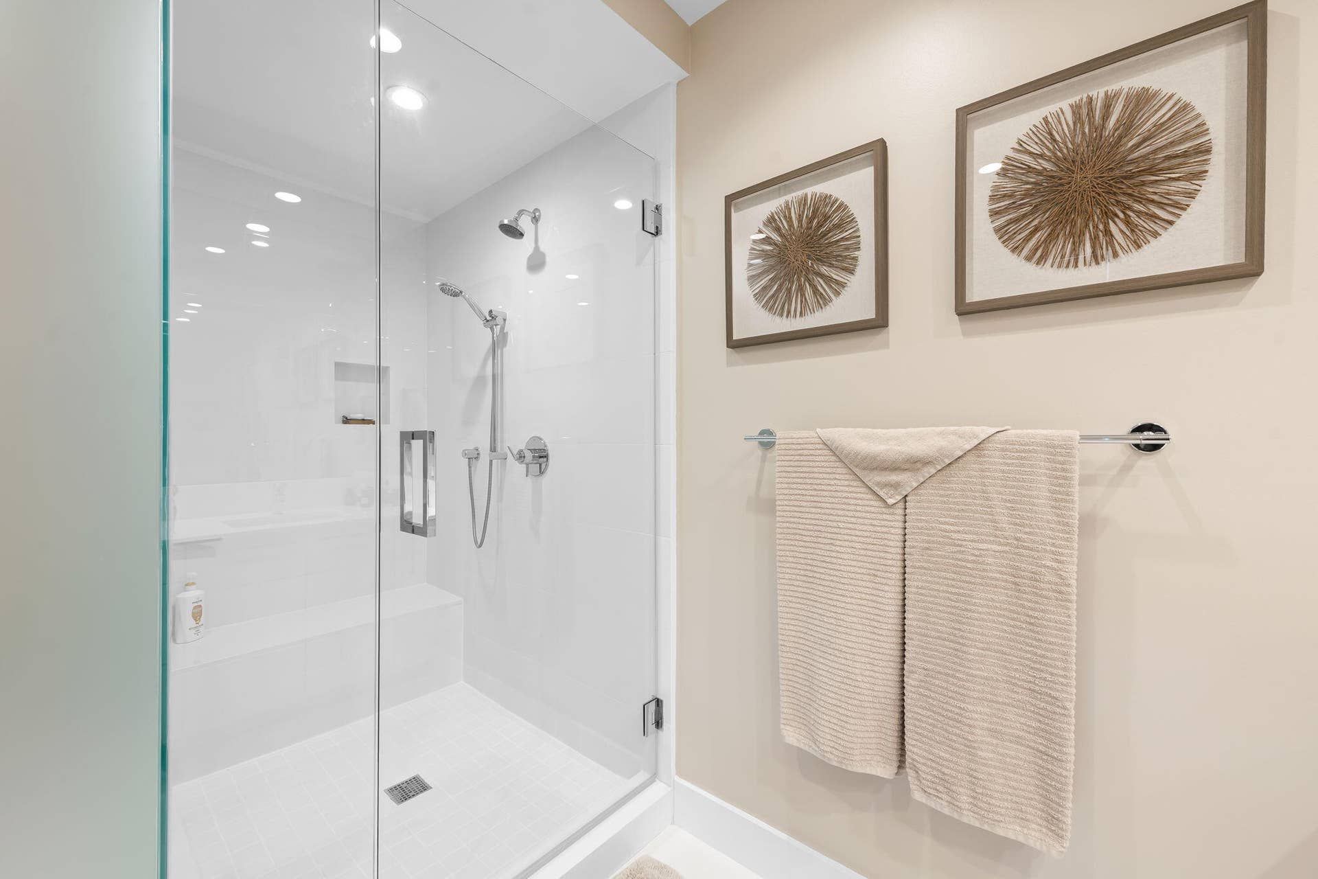 100 E Las Olas Boulevard, #3804, Fort Lauderdale, FL 33301 Glass-enclosed shower featuring a built-in bench, recessed shelf, and dual showerheads
