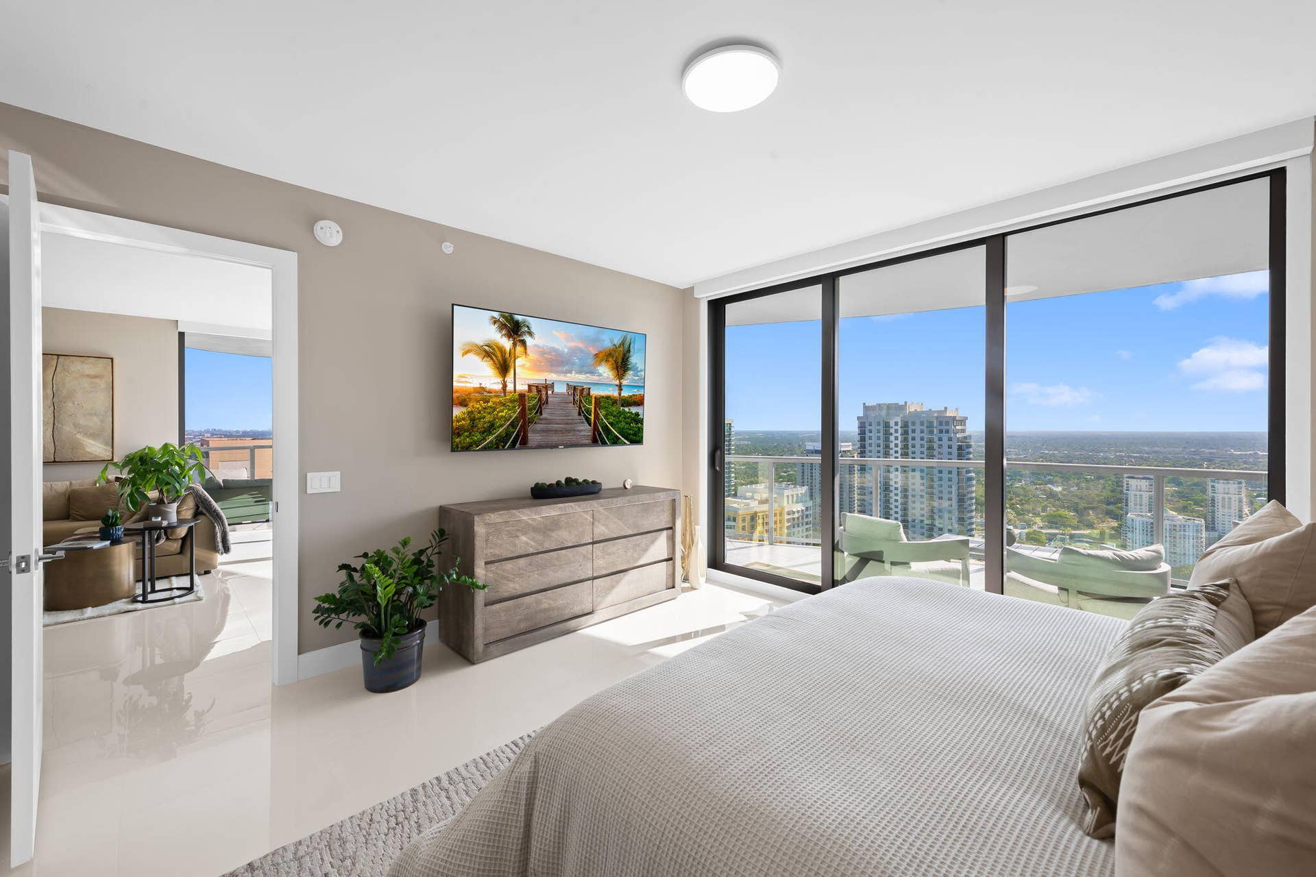 100 E Las Olas Boulevard, #3804, Fort Lauderdale, FL 33301 Expansive windows frame the cityscape, complemented by a private balcony with glass railings