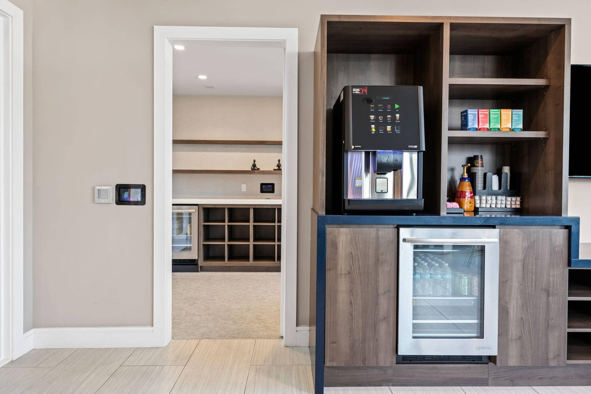 100 E Las Olas Boulevard, #3804, Fort Lauderdale, FL 33301 Built-in cabinetry with wood-finish doors and shelving, integrated beverage refrigerator, and a recessed coffee station