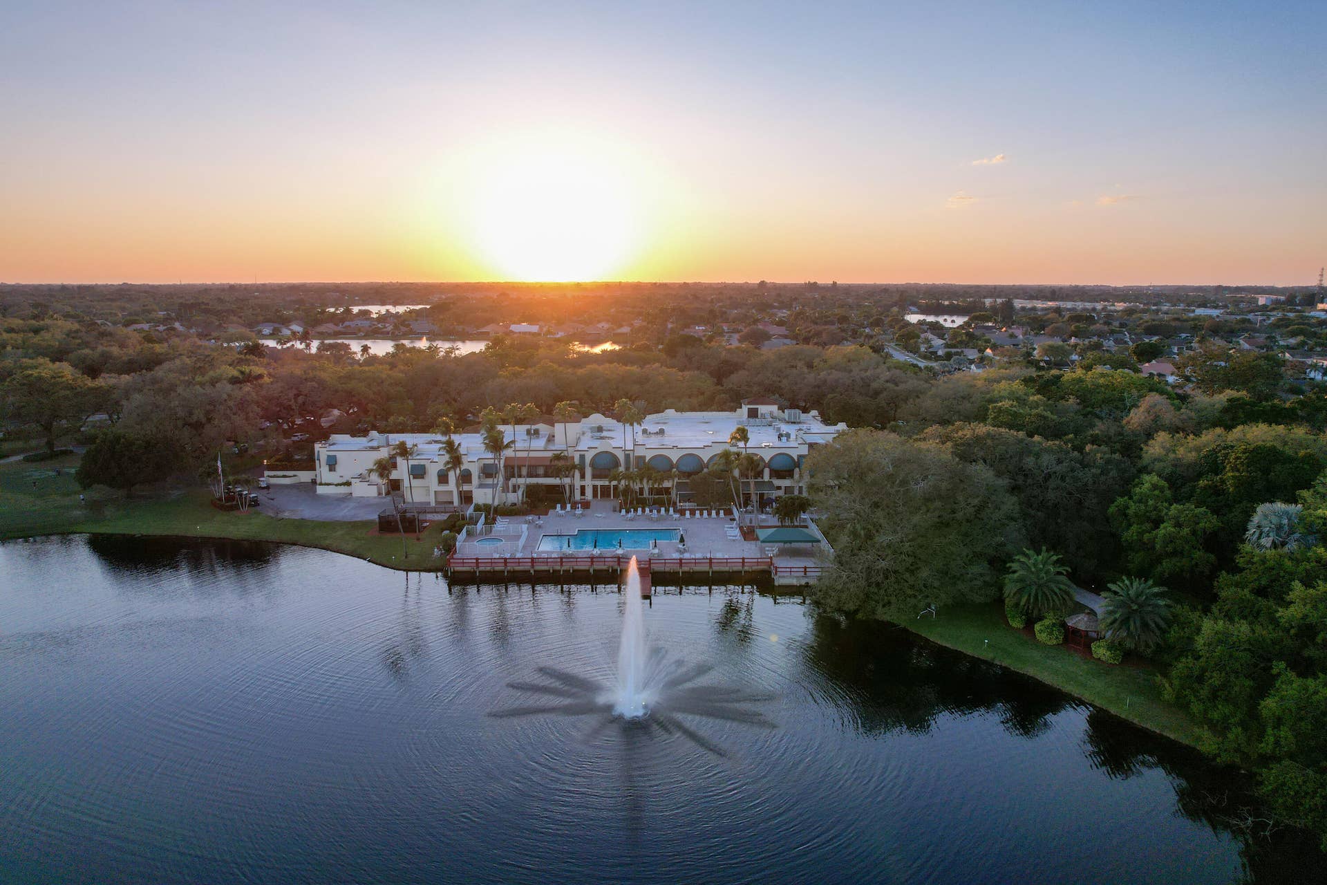 Sunset overhead of the Country Club, lake,fountain, pool and Country Club House.