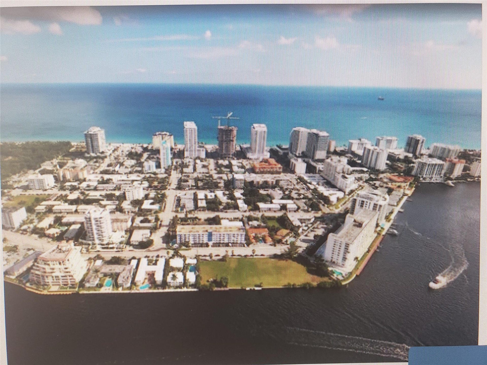 550 Bayshore Drive, #102, Fort Lauderdale, FL 33304 Bayshossre Embassy condominium is pictured in this photo opposite the green empty lot on the Intracoastal waterway