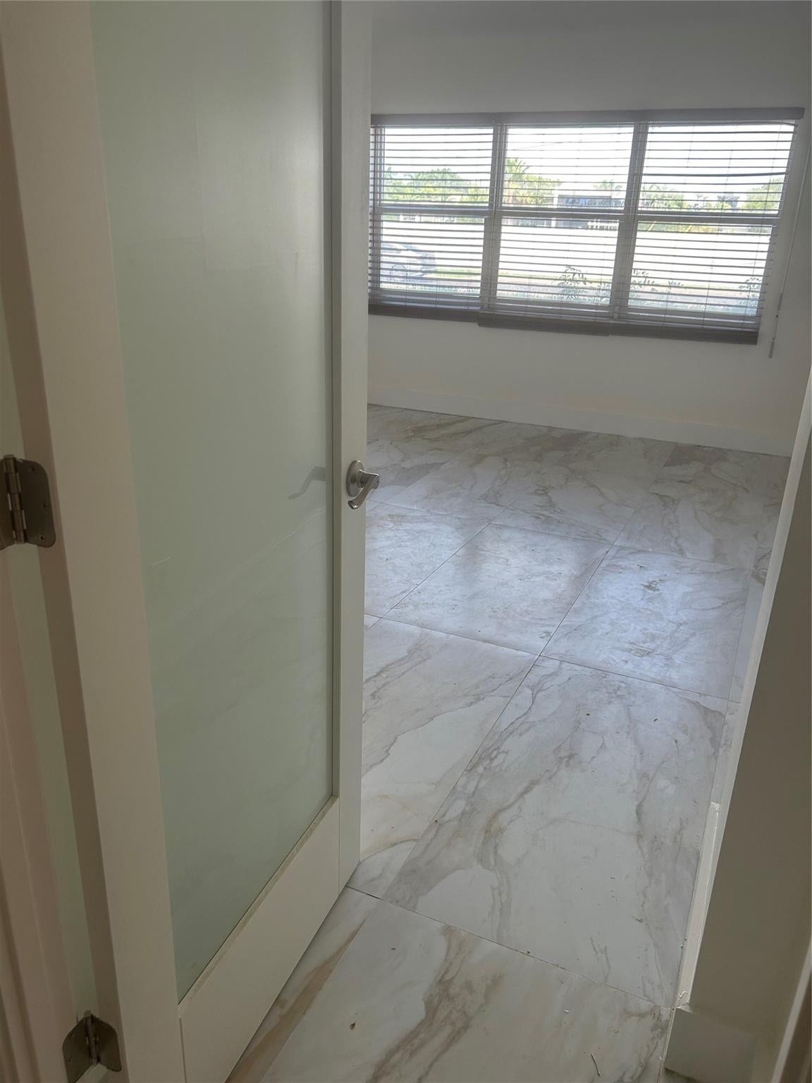 550 Bayshore Drive, #102, Fort Lauderdale, FL 33304 ceramic tile flooring leads into this area. A frosted glass door opens into the room.the window faces west where the views of boats and sunsets are visible. There is wooden horizontal blinds window covering. Hurricane shutters attached to outer window with a roll down manual rod. Fiber internet access modem is included and, in the maintenance fees. there is a walk in closet.