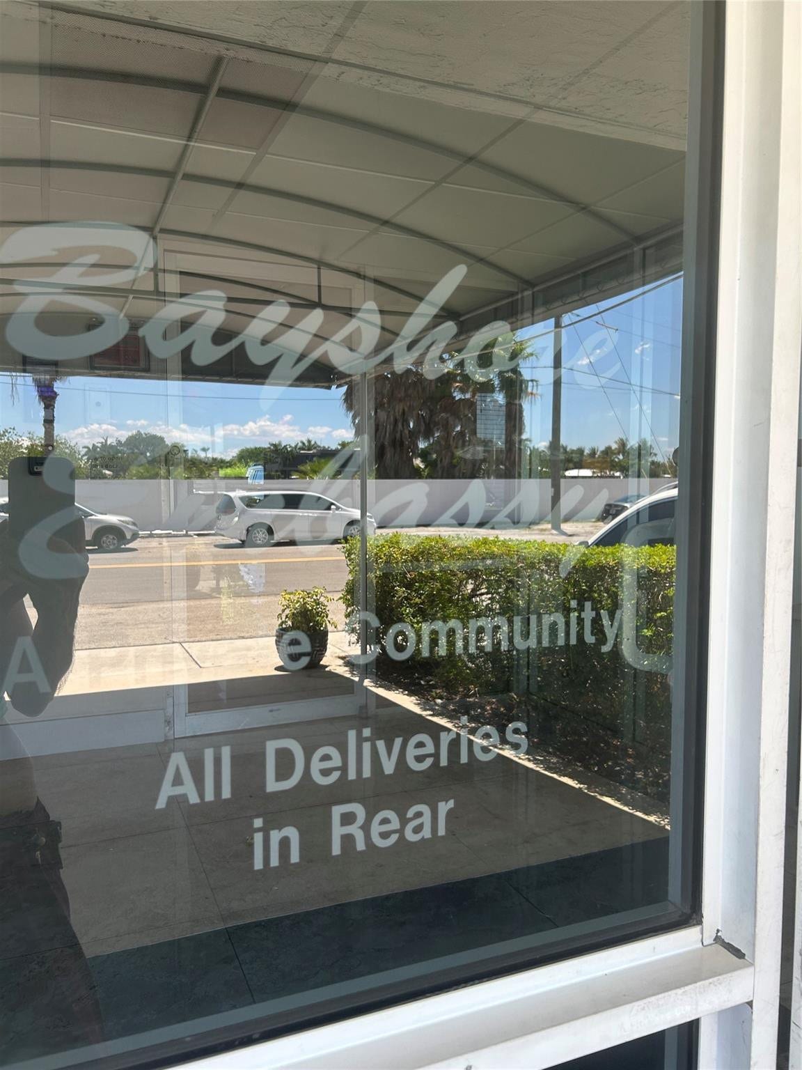 550 Bayshore Drive, #102, Fort Lauderdale, FL 33304 step up to glass door entry where there is sitting lobby with intercom, surveillancecameras, face recognition system using FOB access.