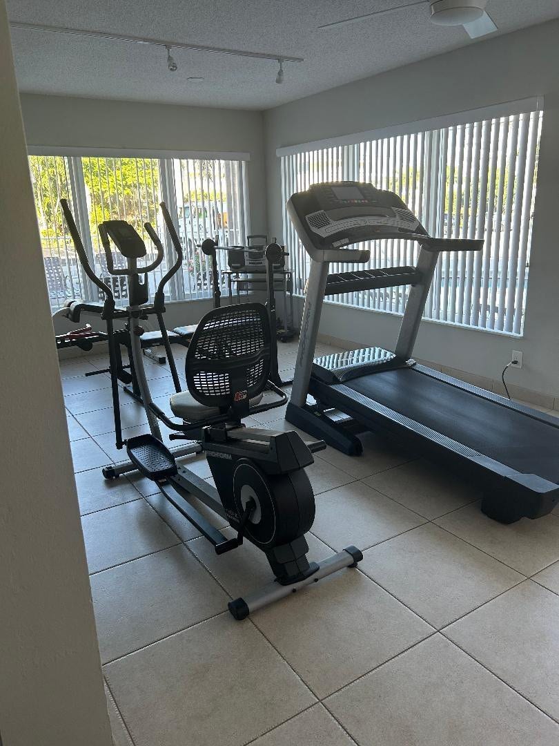 550 Bayshore Drive, #102, Fort Lauderdale, FL 33304 gym area in rec room has full length windows, audio system, ceiling lighting n fans, centeral ac, equipment for exercise