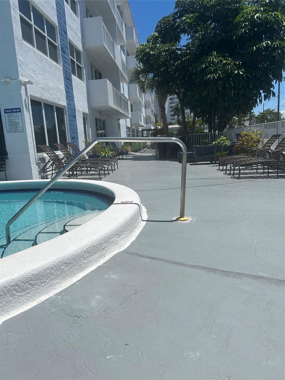 550 Bayshore Drive, #102, Fort Lauderdale, FL 33304 outdoor area is fenced and has heated pool with steps and railing, lounge chairs, shower