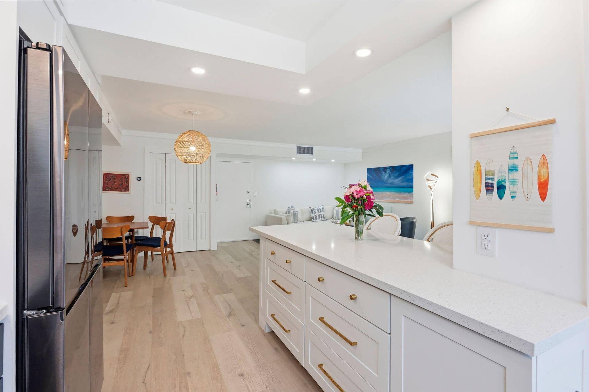 1239 Hillsboro Mile, #302, Hillsboro Beach, FL 33062 Kitchen island with a light-toned countertop, white cabinetry, and gold-toned hardware