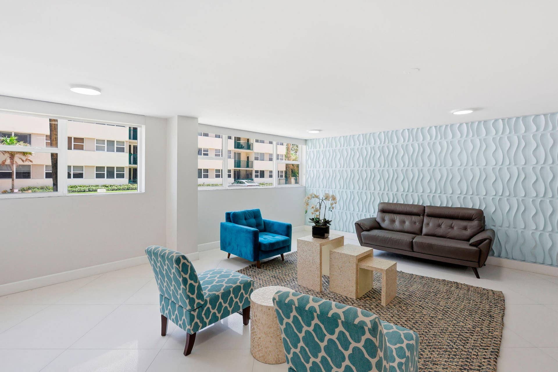 1239 Hillsboro Mile, #302, Hillsboro Beach, FL 33062 Spacious common area featuring a textured accent wall, recessed lighting, large windows bringing the outside in!