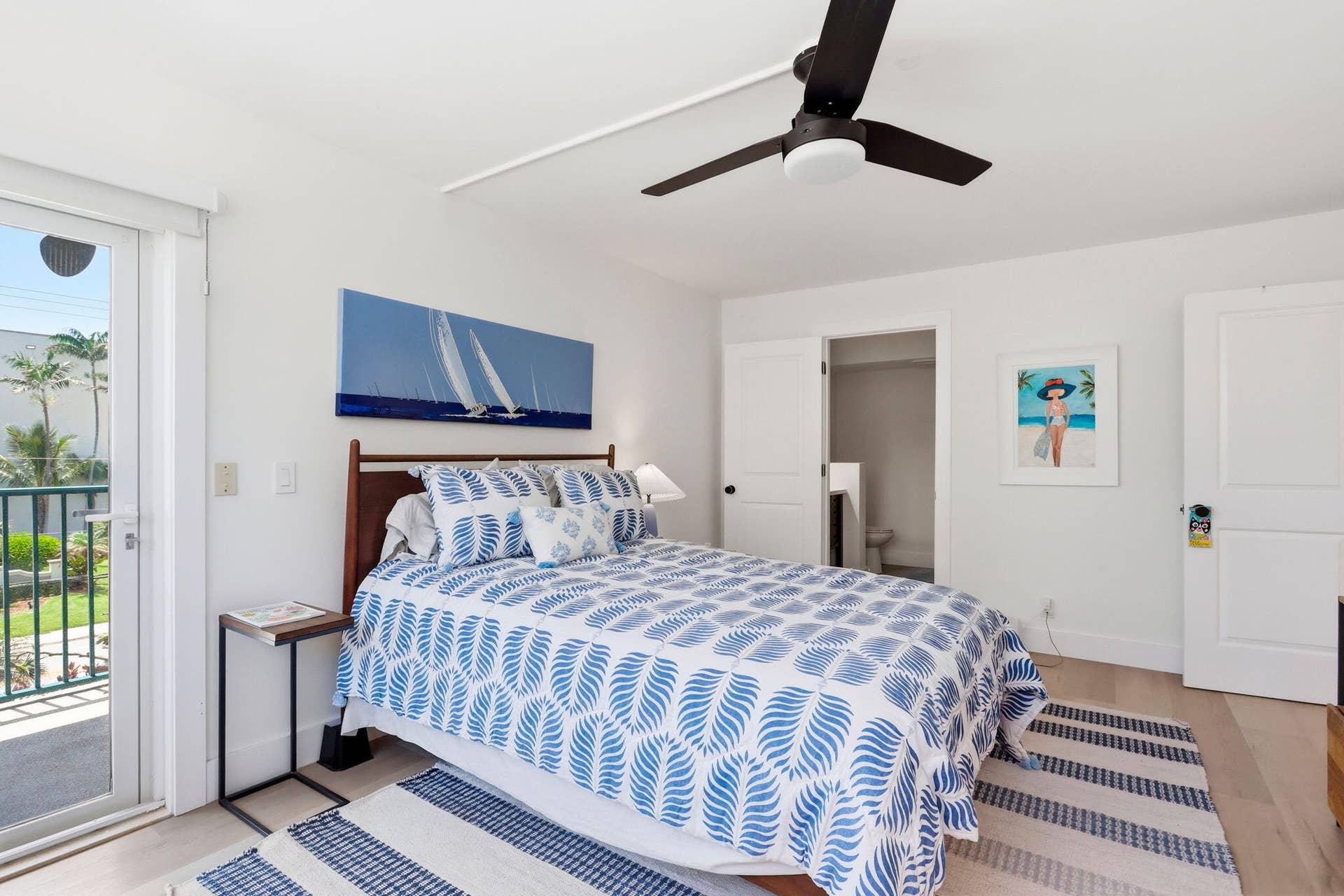 1239 Hillsboro Mile, #302, Hillsboro Beach, FL 33062 Light wood-finish flooring complements white walls in this bedroom, featuring a glass-paneled door opening to a balcony with views of the intracoastal and sunsets!