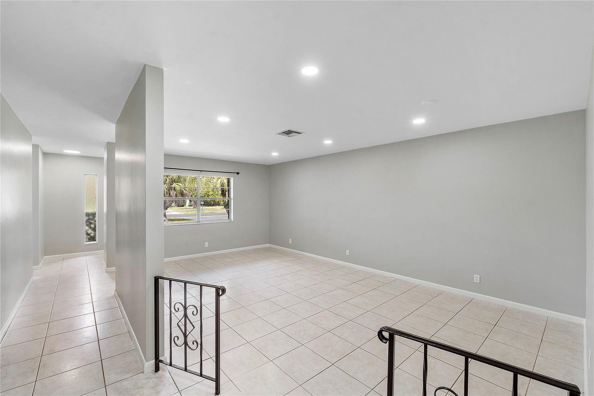 3843 NW 81st Terrace, Coral Springs, Coral Springs, FL 33065 Open-concept living area featuring neutral-toned walls, recessed lighting, and large format tile flooring