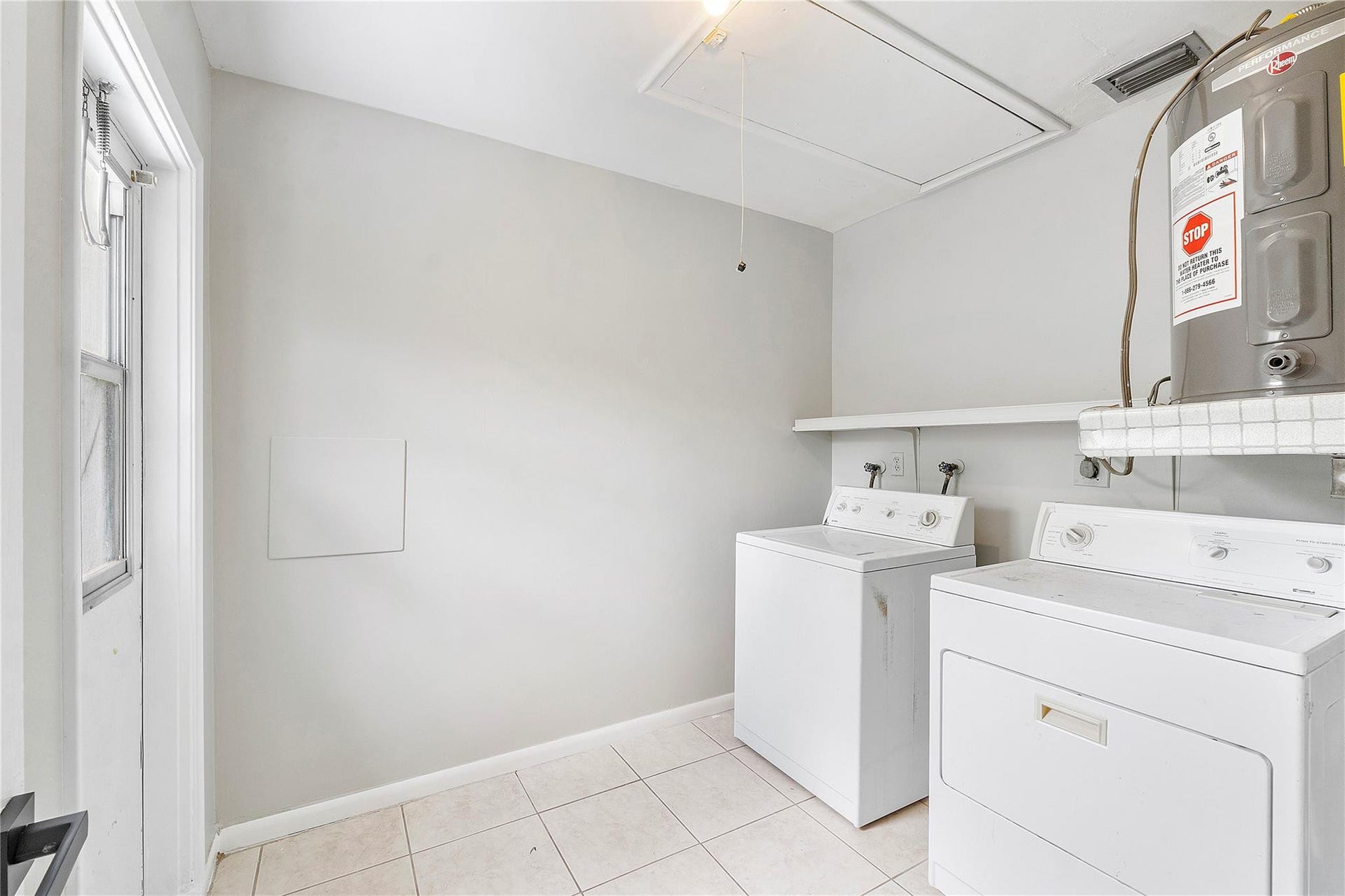 3843 NW 81st Terrace, Coral Springs, Coral Springs, FL 33065 Dedicated laundry area featuring a water heater, tile flooring, and light gray walls