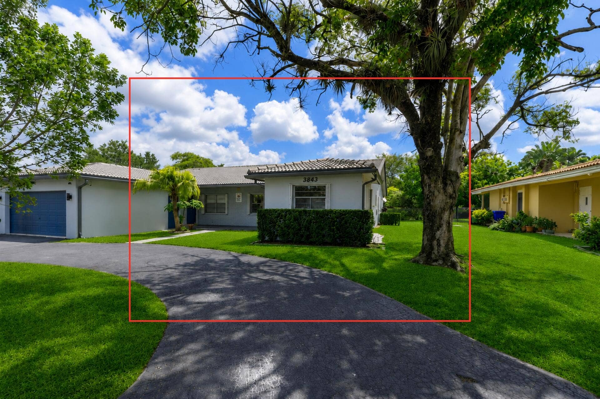 3843 NW 81st Terrace, Coral Springs, Coral Springs, FL 33065 Gray stucco exterior with a tiled roof, featuring an attached garage with a dark blue door and a paved driveway