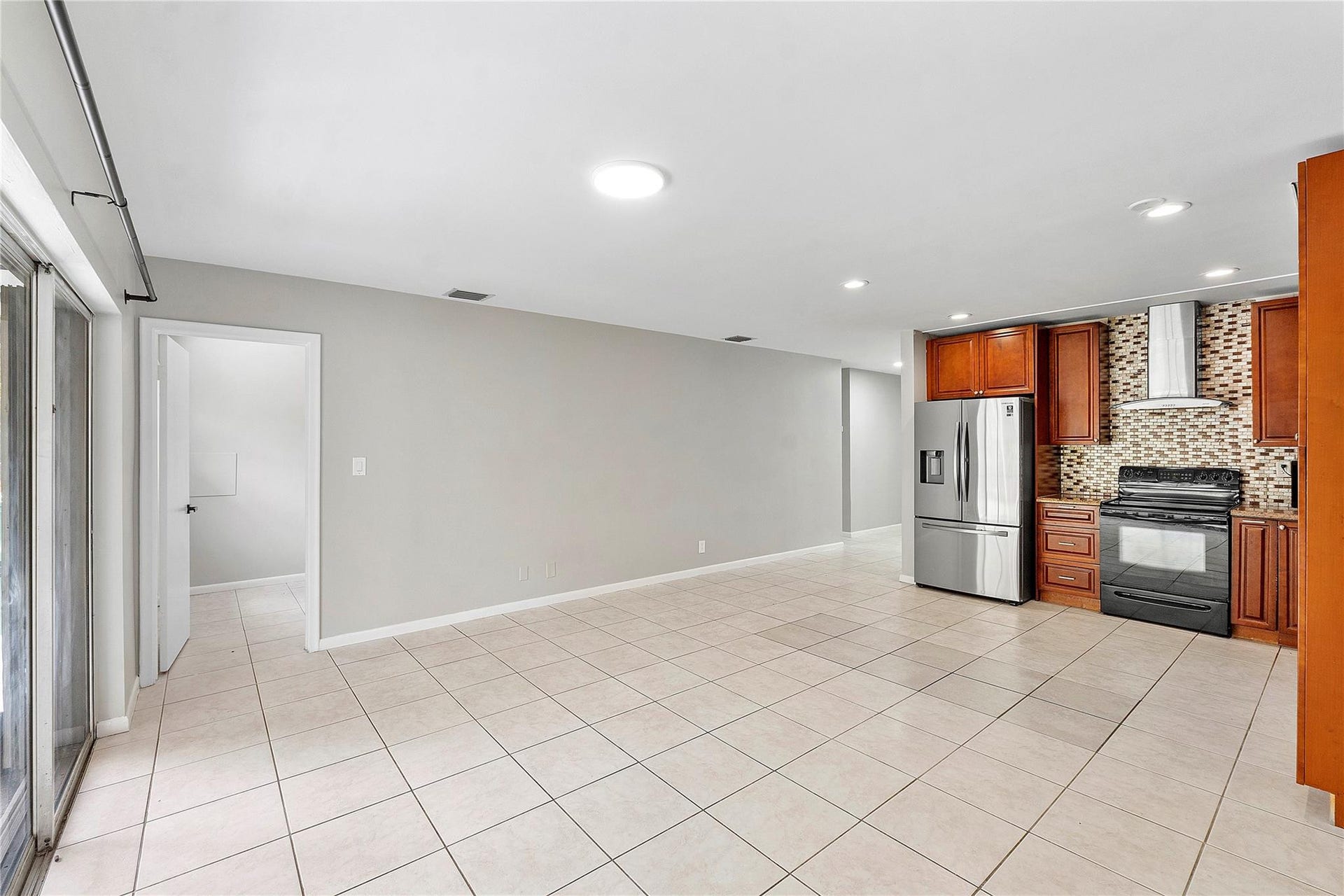 3843 NW 81st Terrace, Coral Springs, Coral Springs, FL 33065 Open-concept living area featuring light-toned tile flooring and recessed lighting