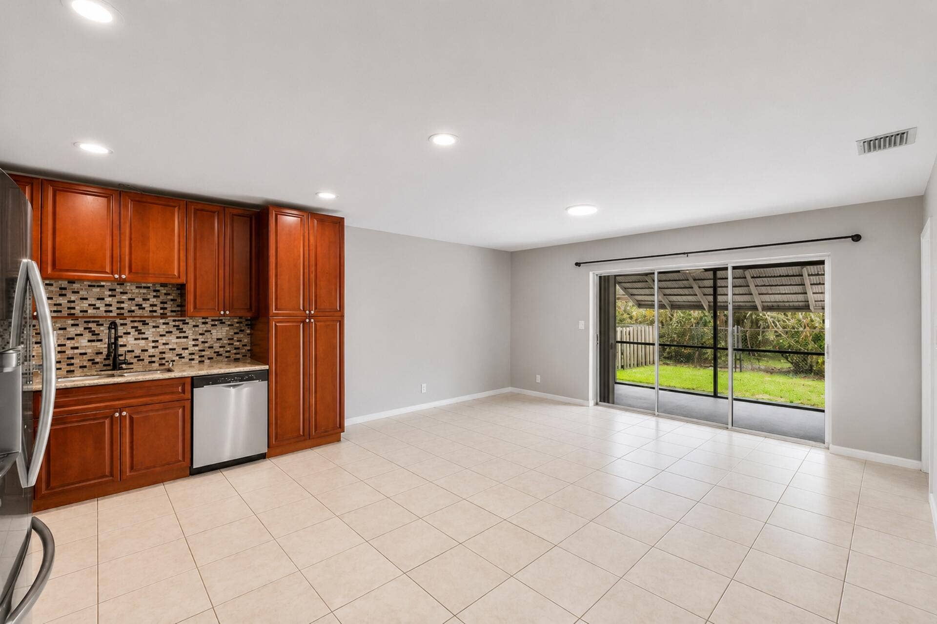 3843 NW 81st Terrace, Coral Springs, Coral Springs, FL 33065 Open-concept living area featuring light-toned tile flooring, recessed lighting, and a neutral wall palette