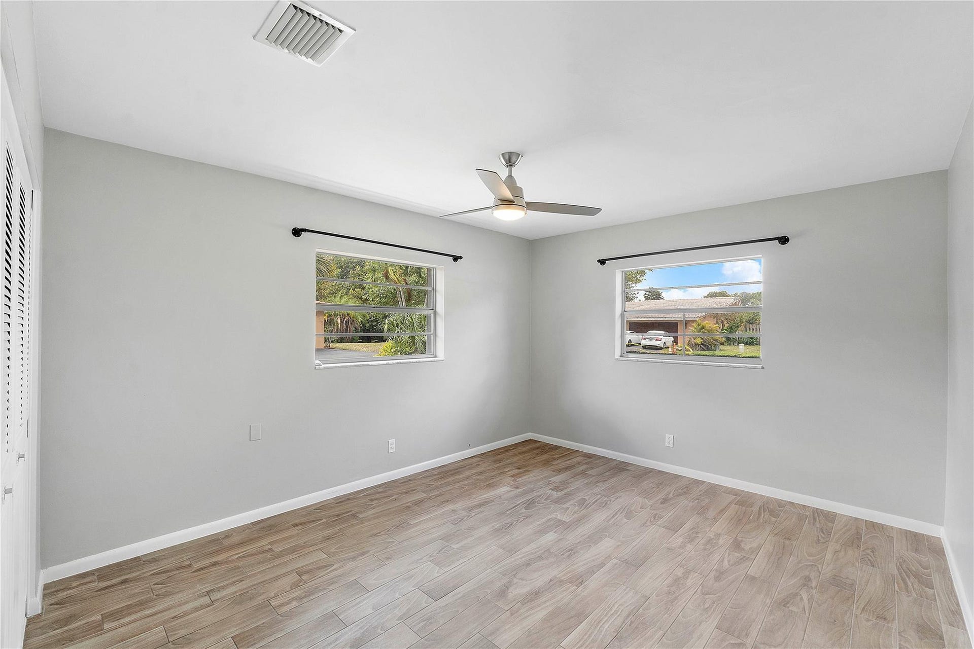 3843 NW 81st Terrace, Coral Springs, Coral Springs, FL 33065 Neutral-toned room featuring wood-finish flooring and light gray walls
