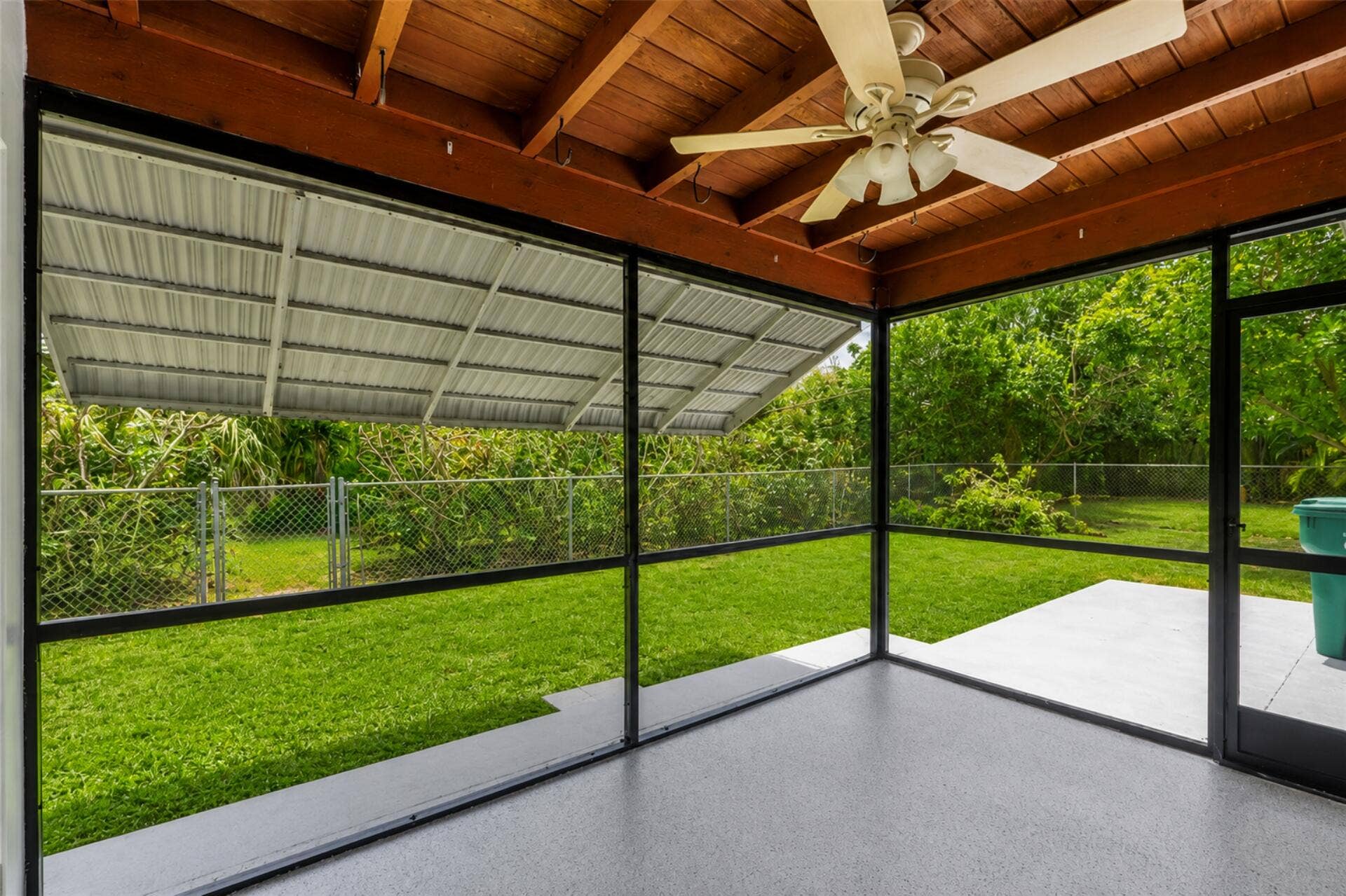 3843 NW 81st Terrace, Coral Springs, Coral Springs, FL 33065 Screened porch featuring a textured concrete floor, a wood plank ceiling, and a ceiling fan