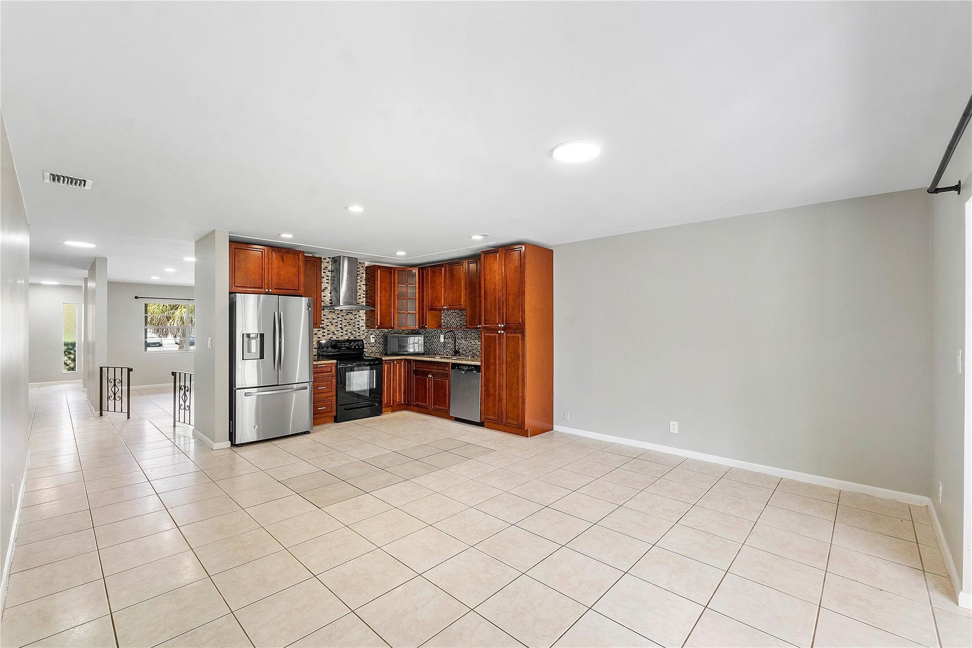 3843 NW 81st Terrace, Coral Springs, Coral Springs, FL 33065 Kitchen featuring wood cabinetry, stainless steel appliances, and a mosaic tile backsplash