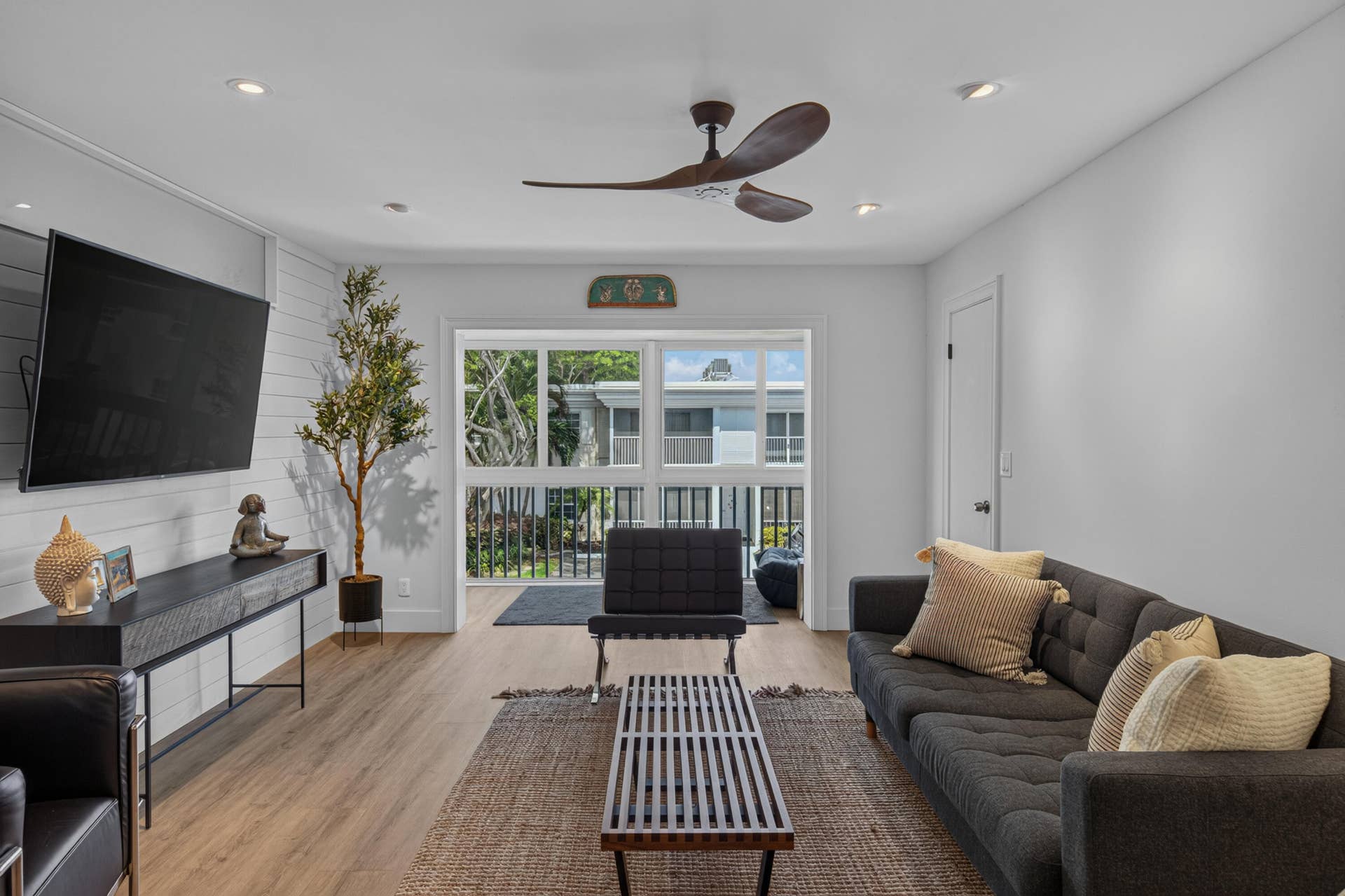Spacious living area featuring wood-look flooring, recessed lighting, and a modern ceiling fan