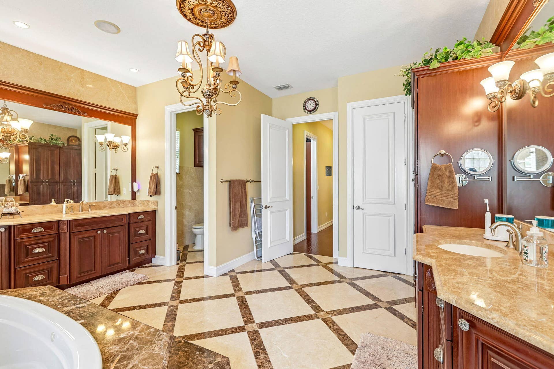 Spacious bathroom featuring diagonal tile flooring with contrasting marble accents