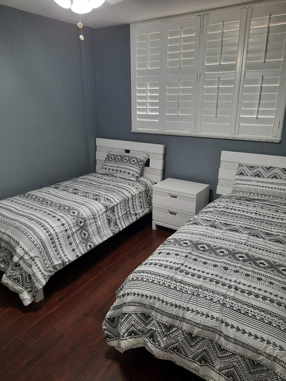 4500 N Federal Highway, #253F, Lighthouse Point, Lighthouse Point, FL 33064 Bedroom featuring dark wood-finish flooring and a window with white plantation shutters