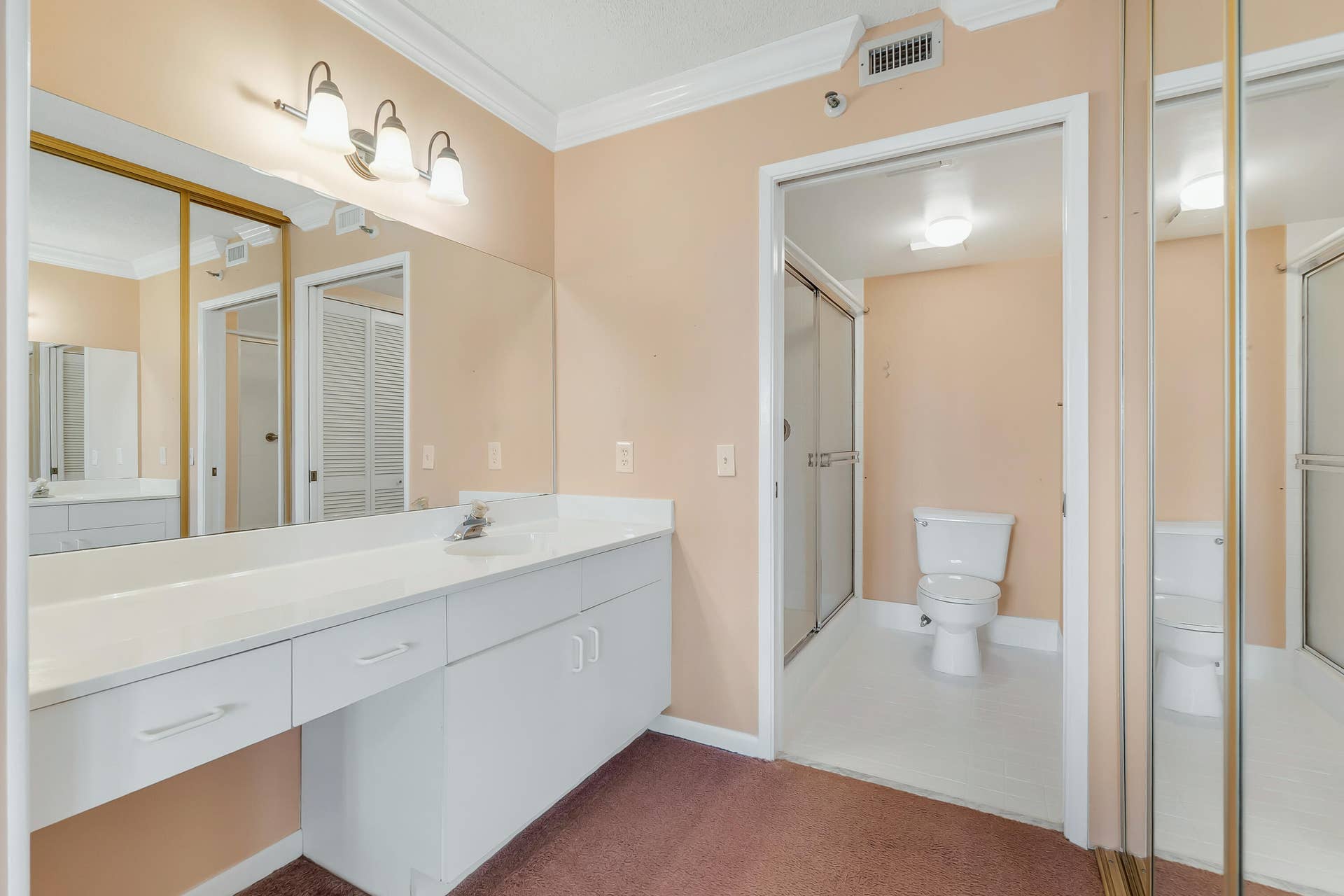 2334 S Cypress Bend Drive, #602, Pompano Beach, FL 33069 Vanity area featuring a long countertop, integrated sink, and white cabinetry with drawer storage