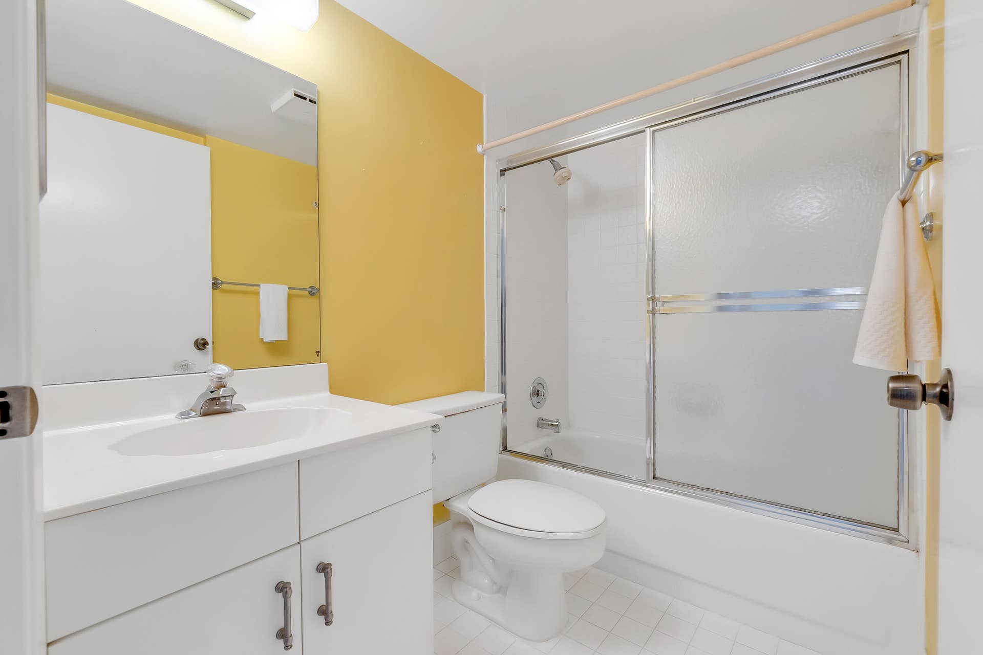 2334 S Cypress Bend Drive, #602, Pompano Beach, FL 33069 Bathroom featuring a white vanity with integrated sink, chrome faucet, and a large wall-mounted mirror
