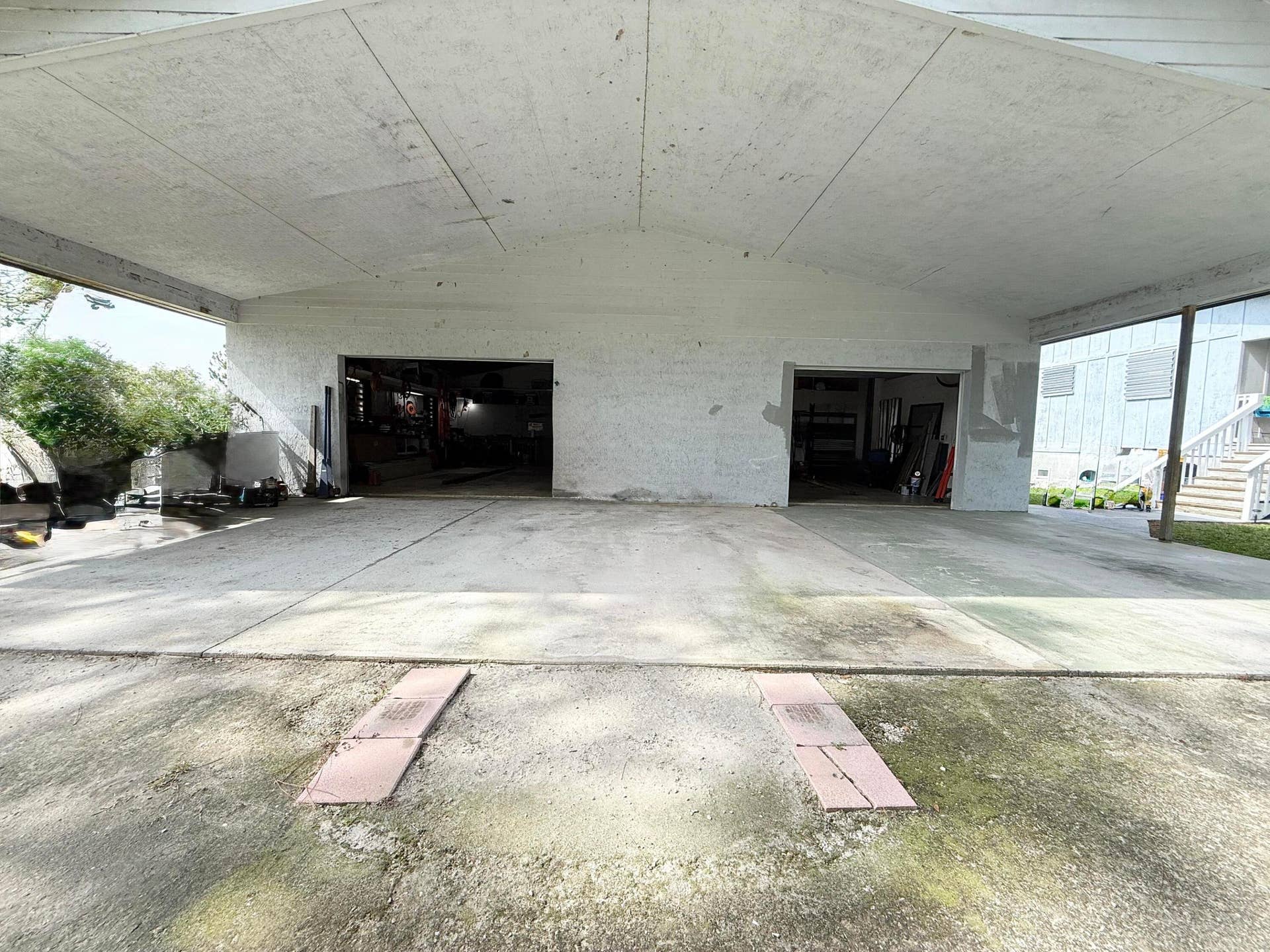 Left bay door is a Roll Up door, Right bay door is a standard house garage door.