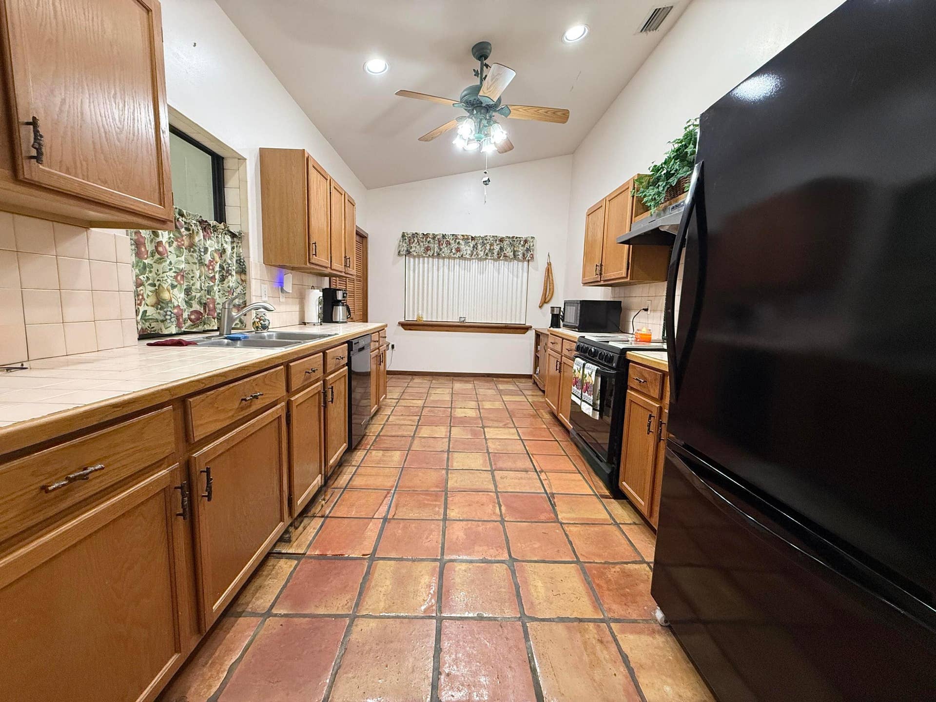 Kitchen facing window, and check out the pass though window to the outside on left!