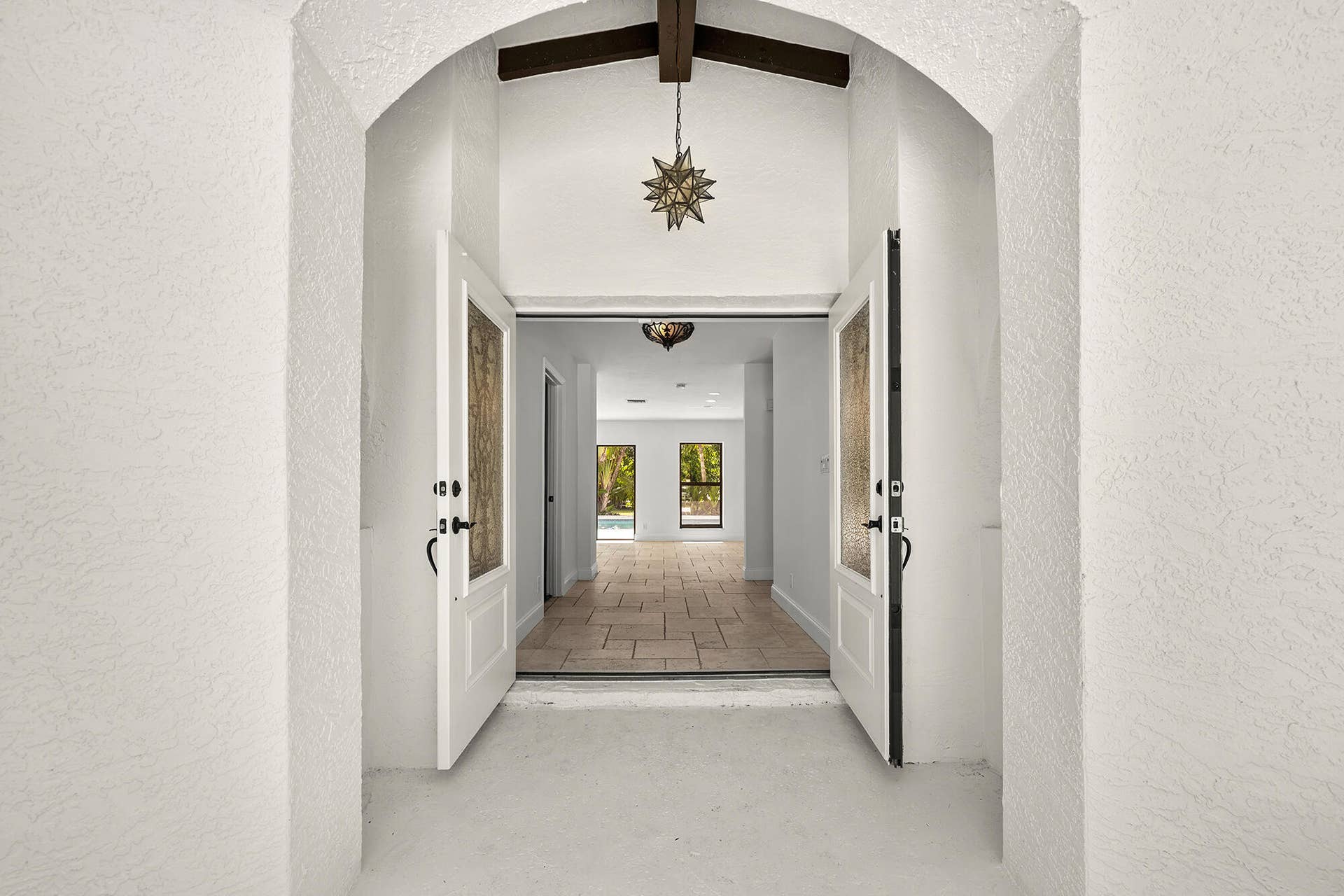 4950 Thoroughbred Lane, Southwest Ranches, FL 33330 Archway entry with double paneled doors featuring decorative glass