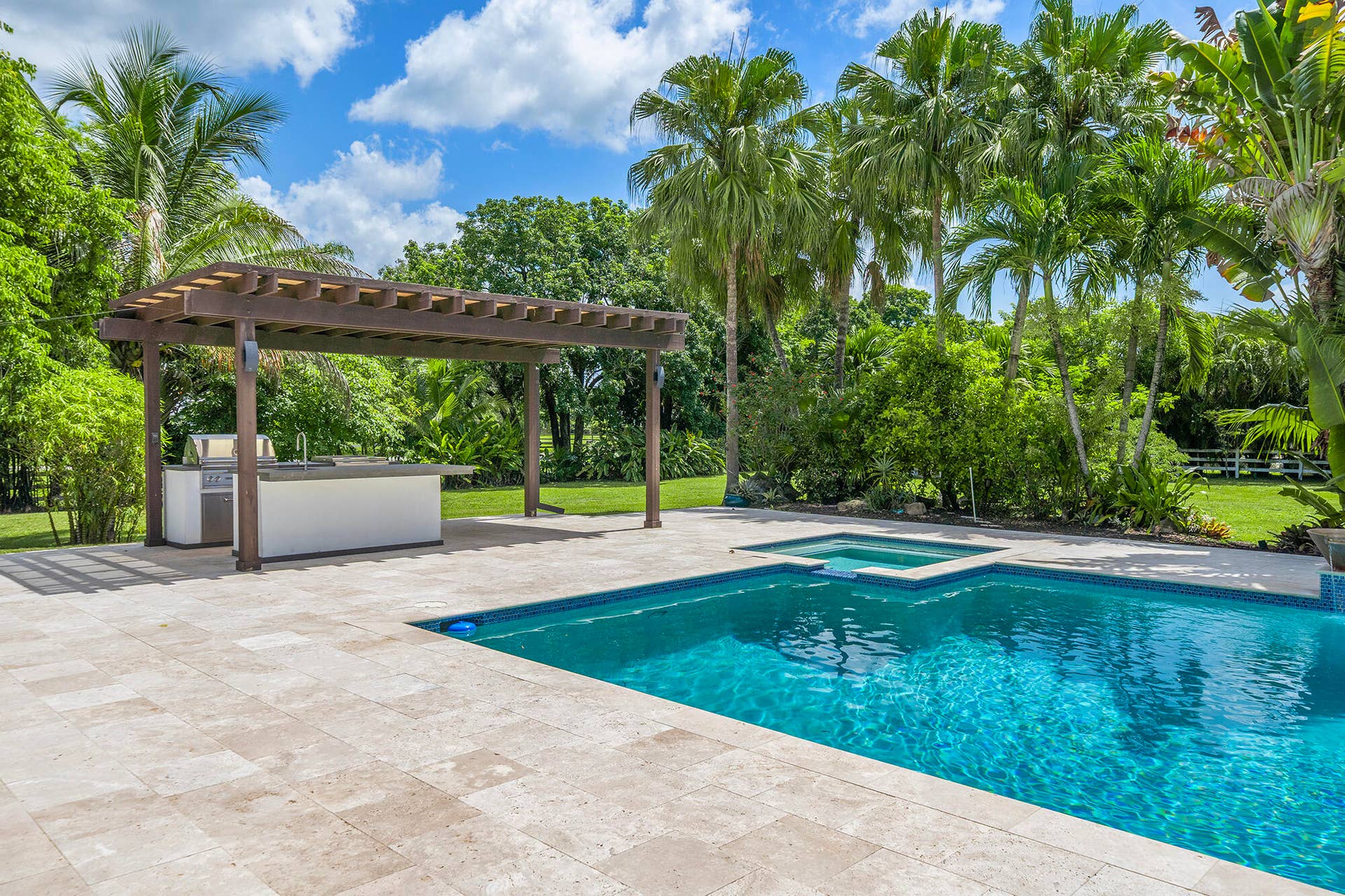 4950 Thoroughbred Lane, Southwest Ranches, FL 33330 Resort-style pool area featuring a rectangular swimming pool with integrated spa