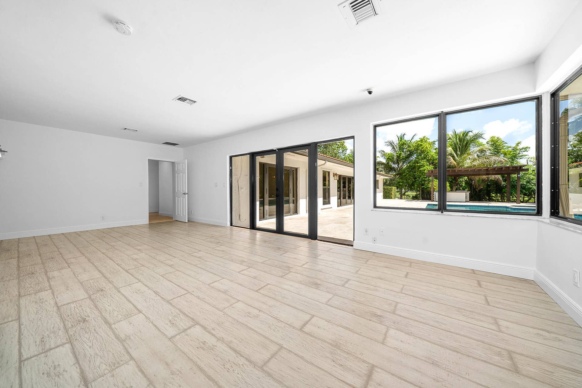 4950 Thoroughbred Lane, Southwest Ranches, FL 33330 Spacious interior room featuring light-colored wood-finish tile flooring and crisp white walls