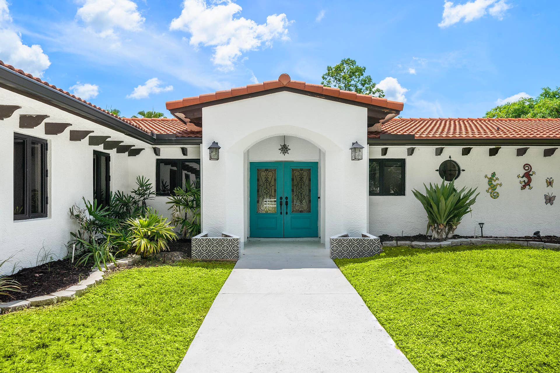 4950 Thoroughbred Lane, Southwest Ranches, FL 33330 Beautifully updated residence featuring a newer terracotta tile roof, white stucco exterior, and a inviting entryway