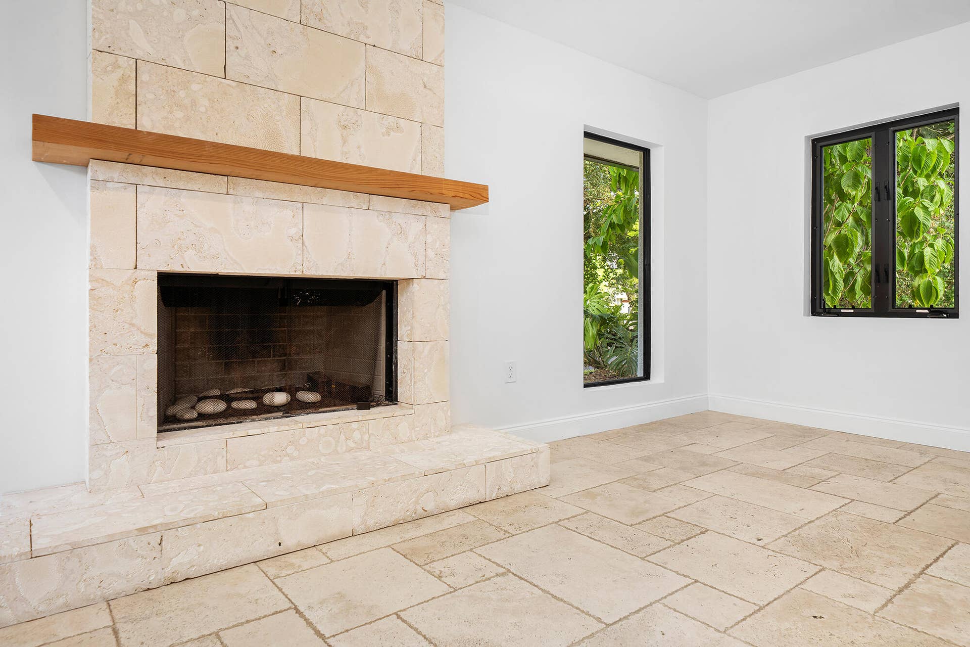 4950 Thoroughbred Lane, Southwest Ranches, FL 33330 Stone-clad fireplace with a natural wood mantle