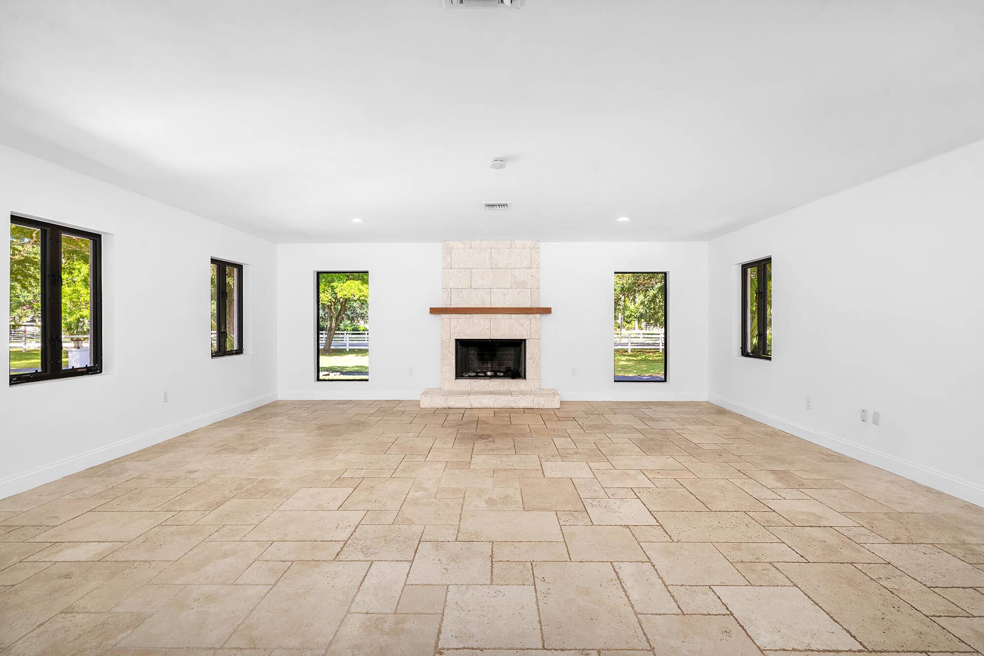 4950 Thoroughbred Lane, Southwest Ranches, FL 33330 Family Room with fireplace and travertine marble floor