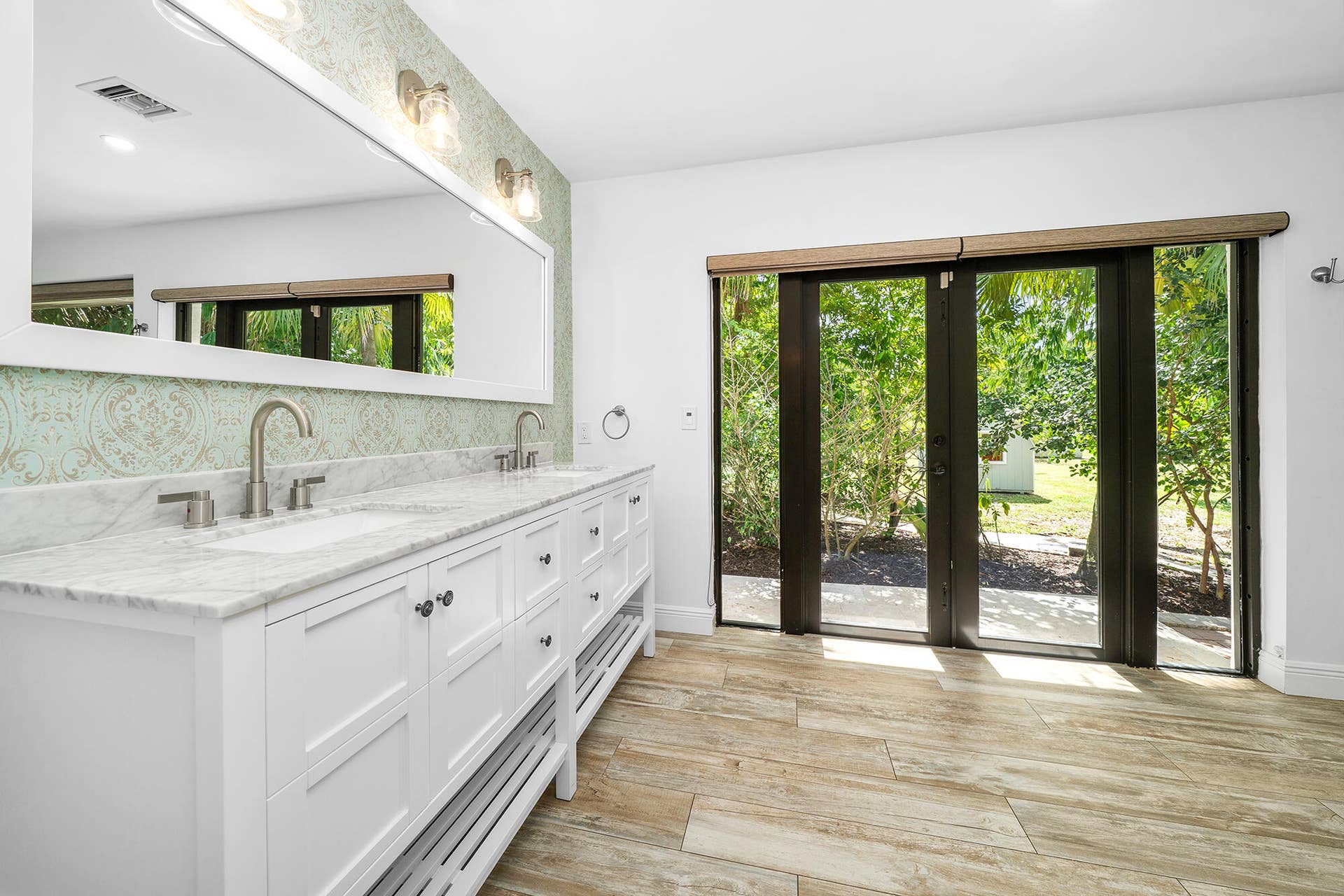 4950 Thoroughbred Lane, Southwest Ranches, FL 33330 Dual vanity with a stone countertop, individual sinks, and brushed nickel fixtures