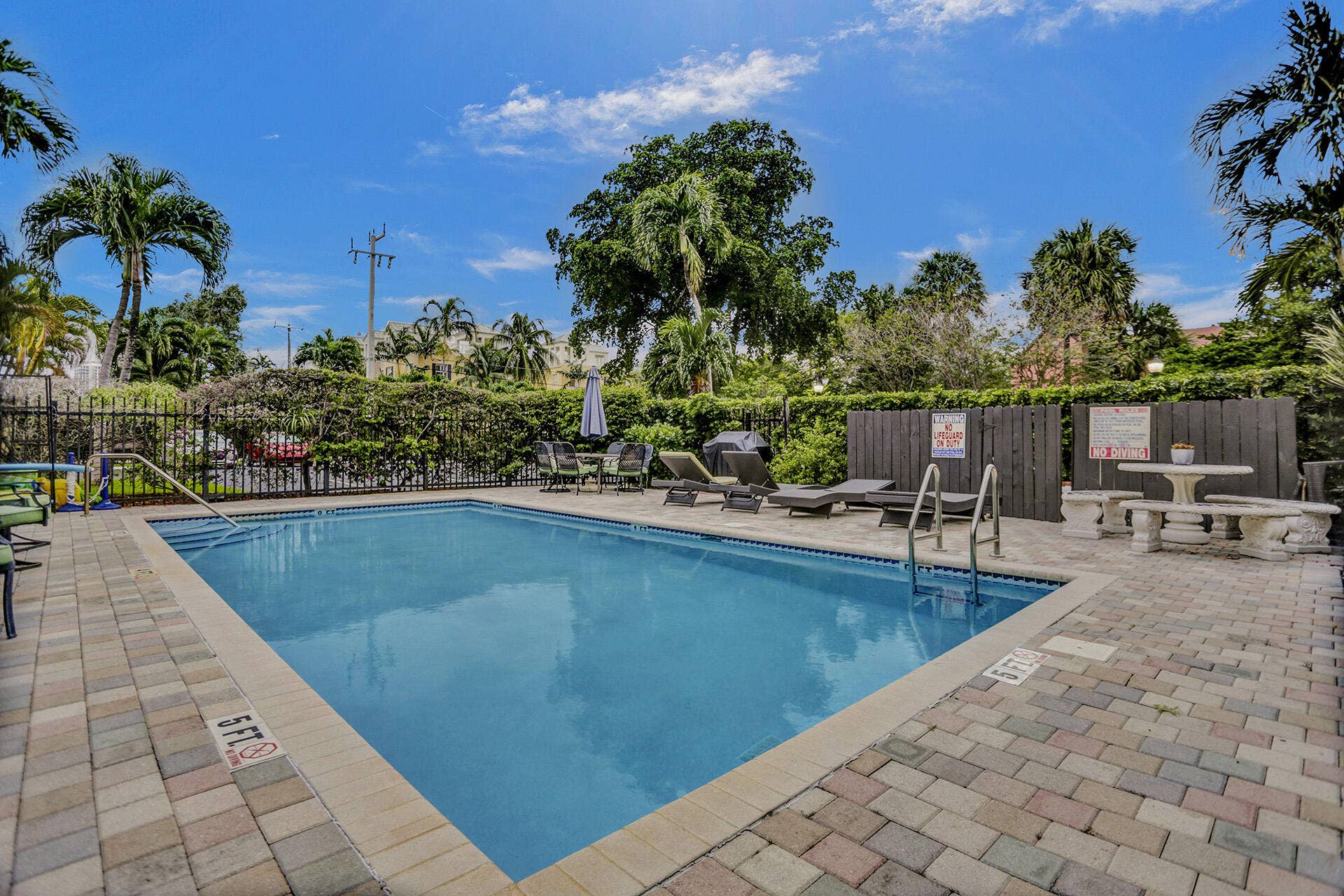 Outdoor swimming pool with integrated steps and metal handrails