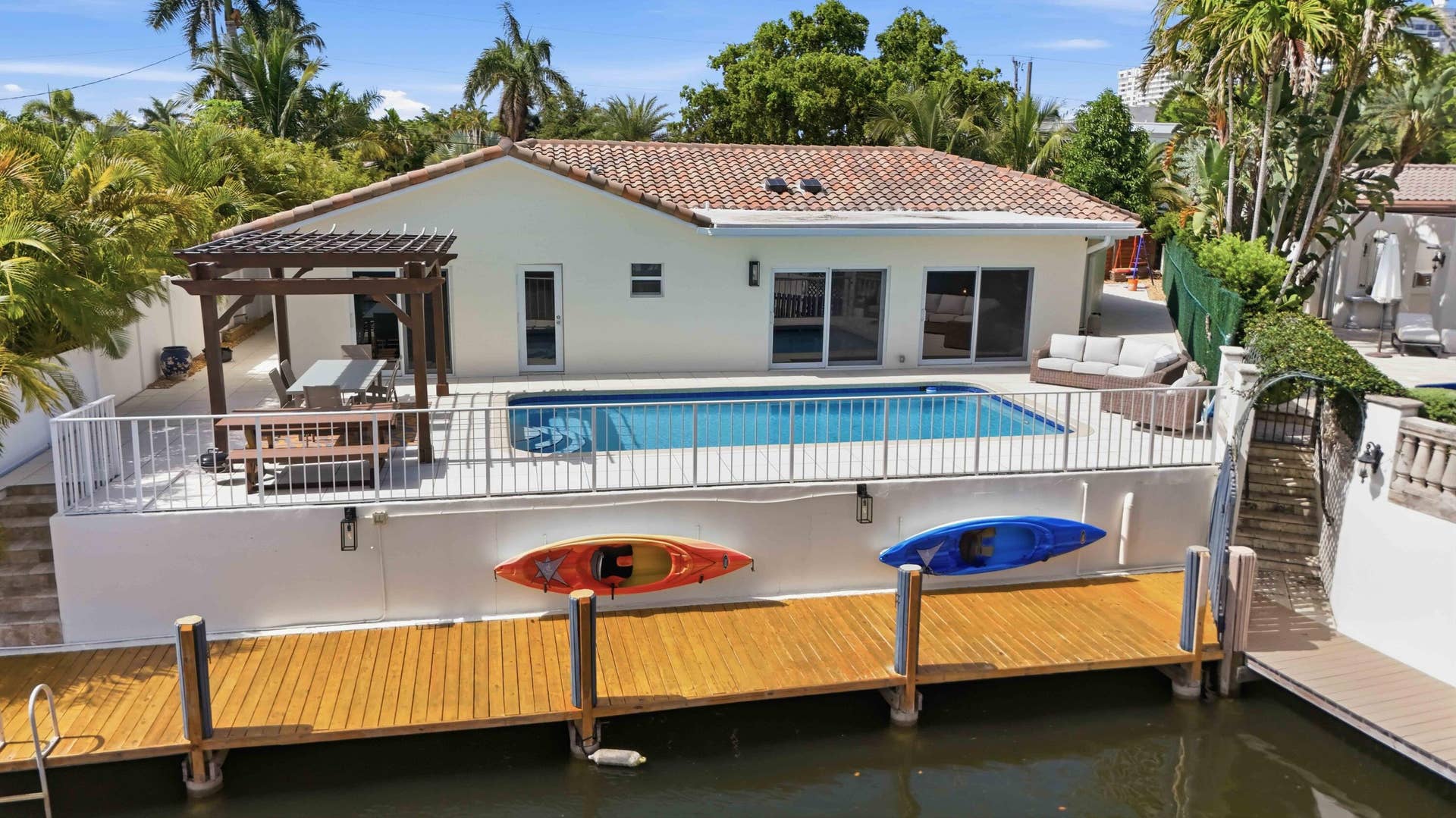 3316 NE 40TH Court, Fort Lauderdale, FL 33308 Bermuda-Riviera Waterfront property featuring a private boat dock, pool, and pergola-covered patio