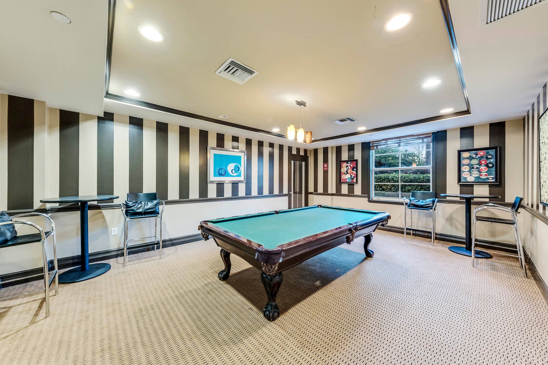 Resident game room featuring a billiards table, darts, and space to relax with friends and neighbors.