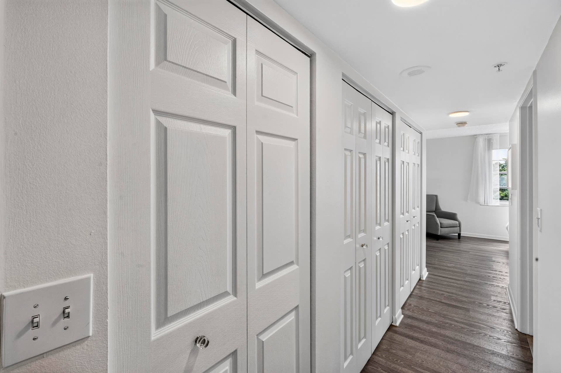 Hallway to primary with multiple closets, built-in linen storage, and abundant storage space help keep everything organized.