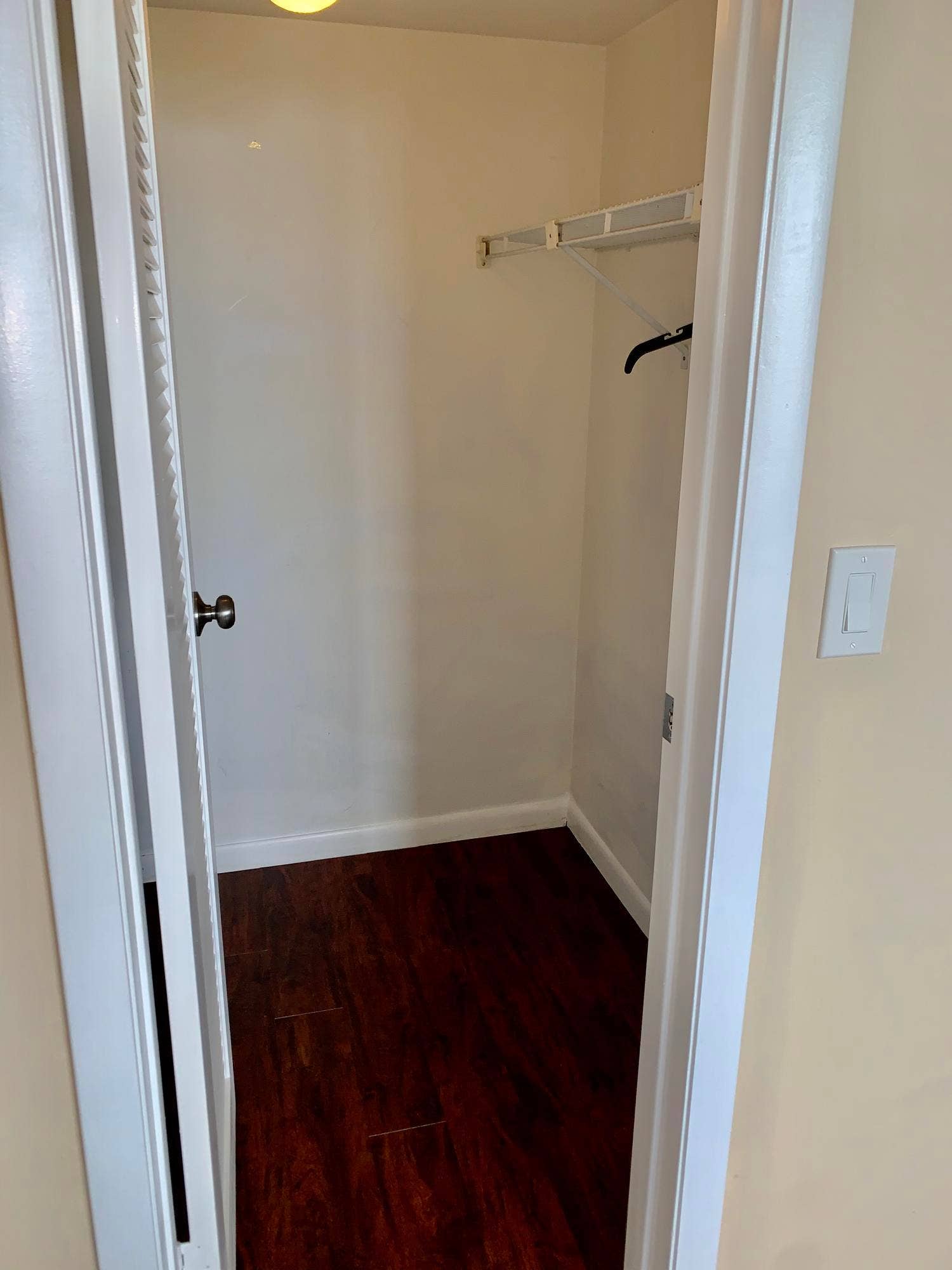 3100 W Rolling Hills Circle, #309, Davie, Davie, FL 33328 Recessed closet featuring wood-finish flooring, white baseboards, and a wire shelving system