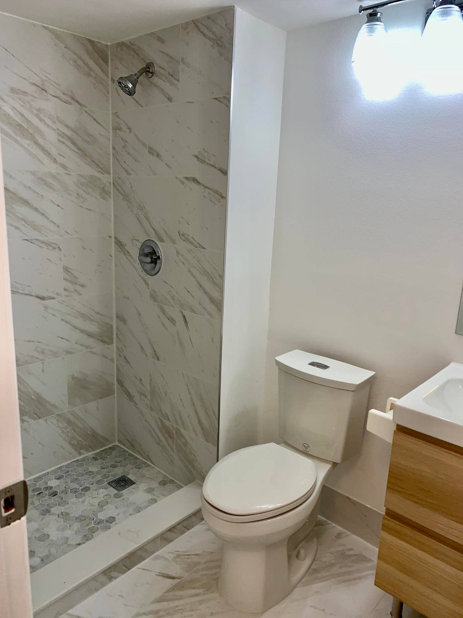 3100 W Rolling Hills Circle, #309, Davie, Davie, FL 33328 Walk-in shower with large-format tile walls and a hexagonal mosaic tile floor
