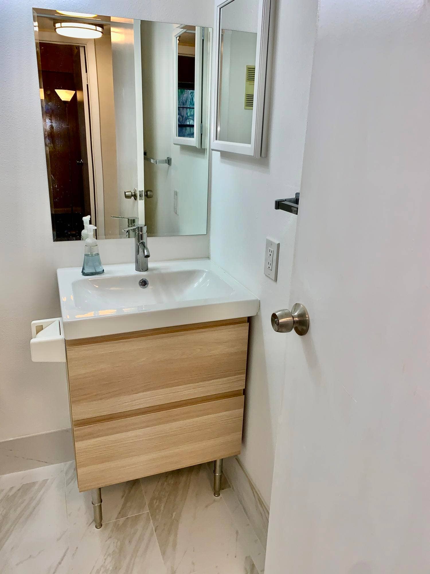 3100 W Rolling Hills Circle, #309, Davie, Davie, FL 33328 Modern vanity featuring a white integrated sink, chrome faucet, and light wood-finish cabinetry on metal legs